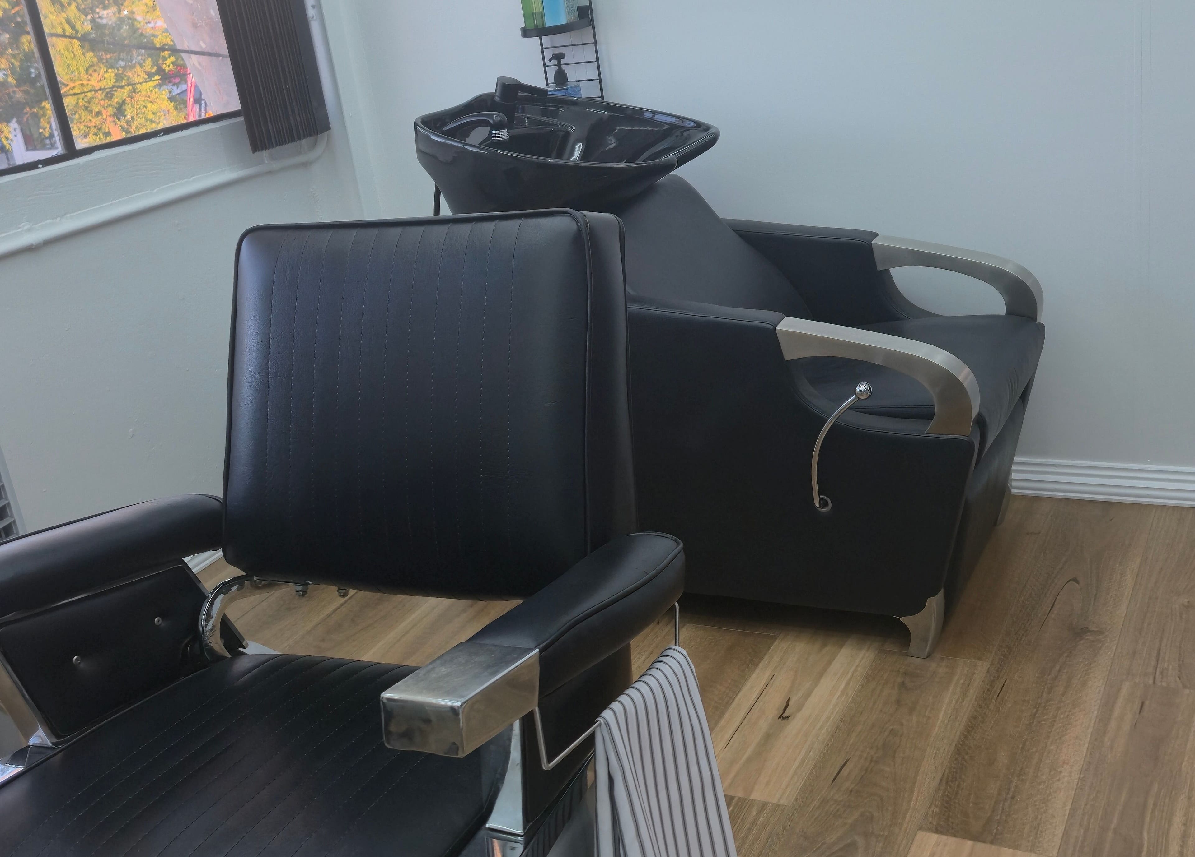 Modern barber chair at Midnight Barber Sydney in Bankstown, New South Wales, AU amidst a stylish setup.