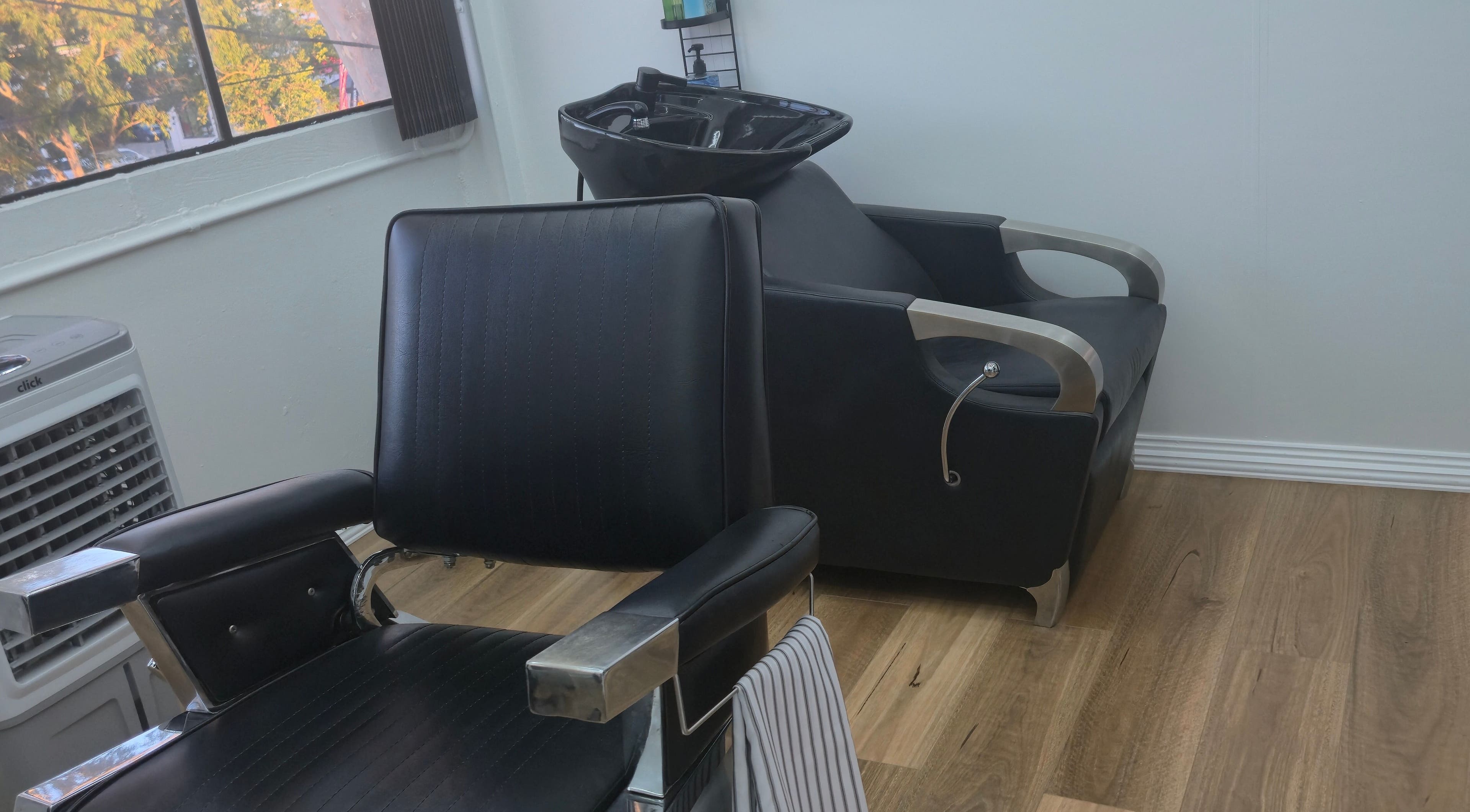 Modern barber chair at Midnight Barber Sydney in Bankstown, New South Wales, AU amidst a stylish setup.