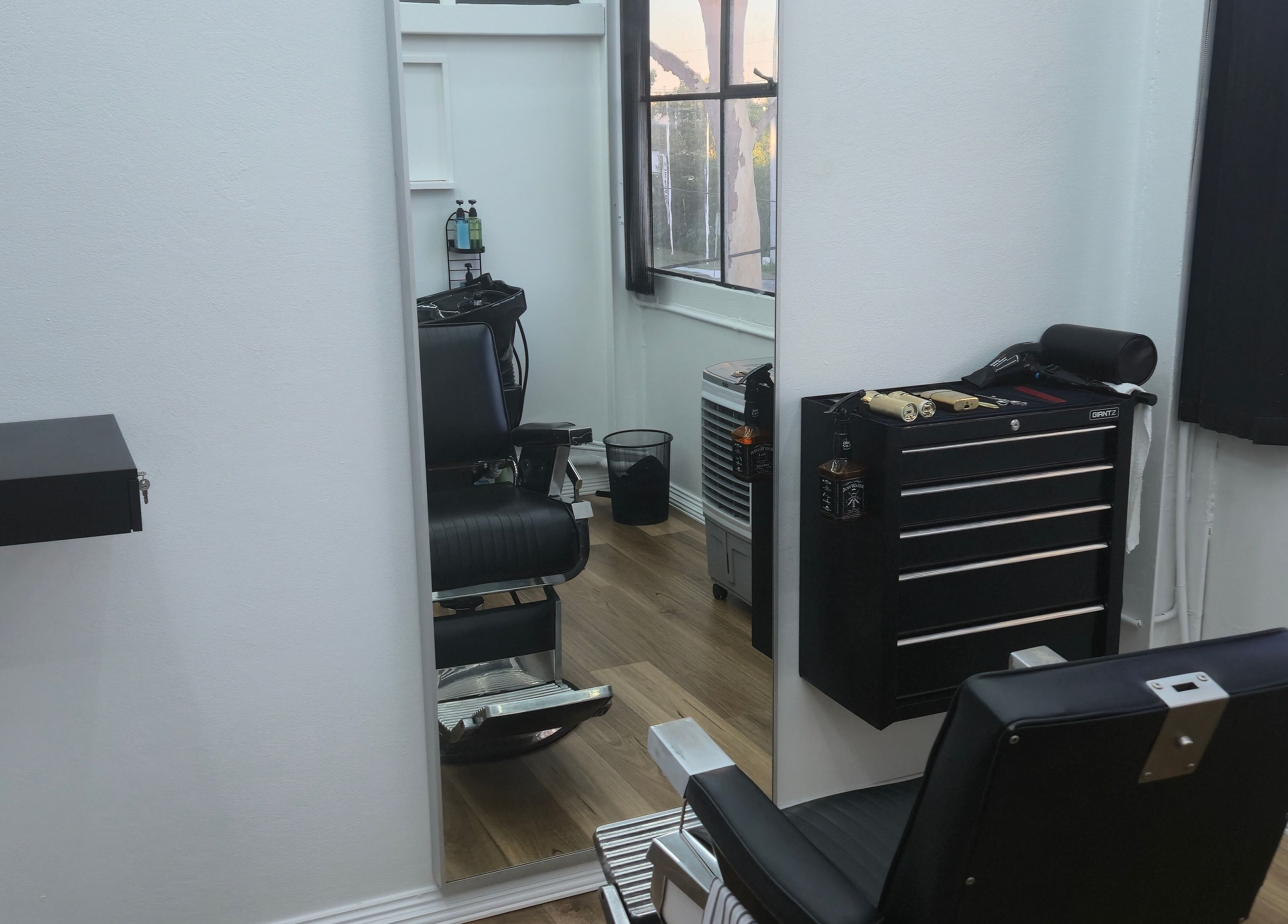 Modern barber chair and tools at Midnight Barber Sydney, Bankstown, New South Wales, AU. Sleek interior design.