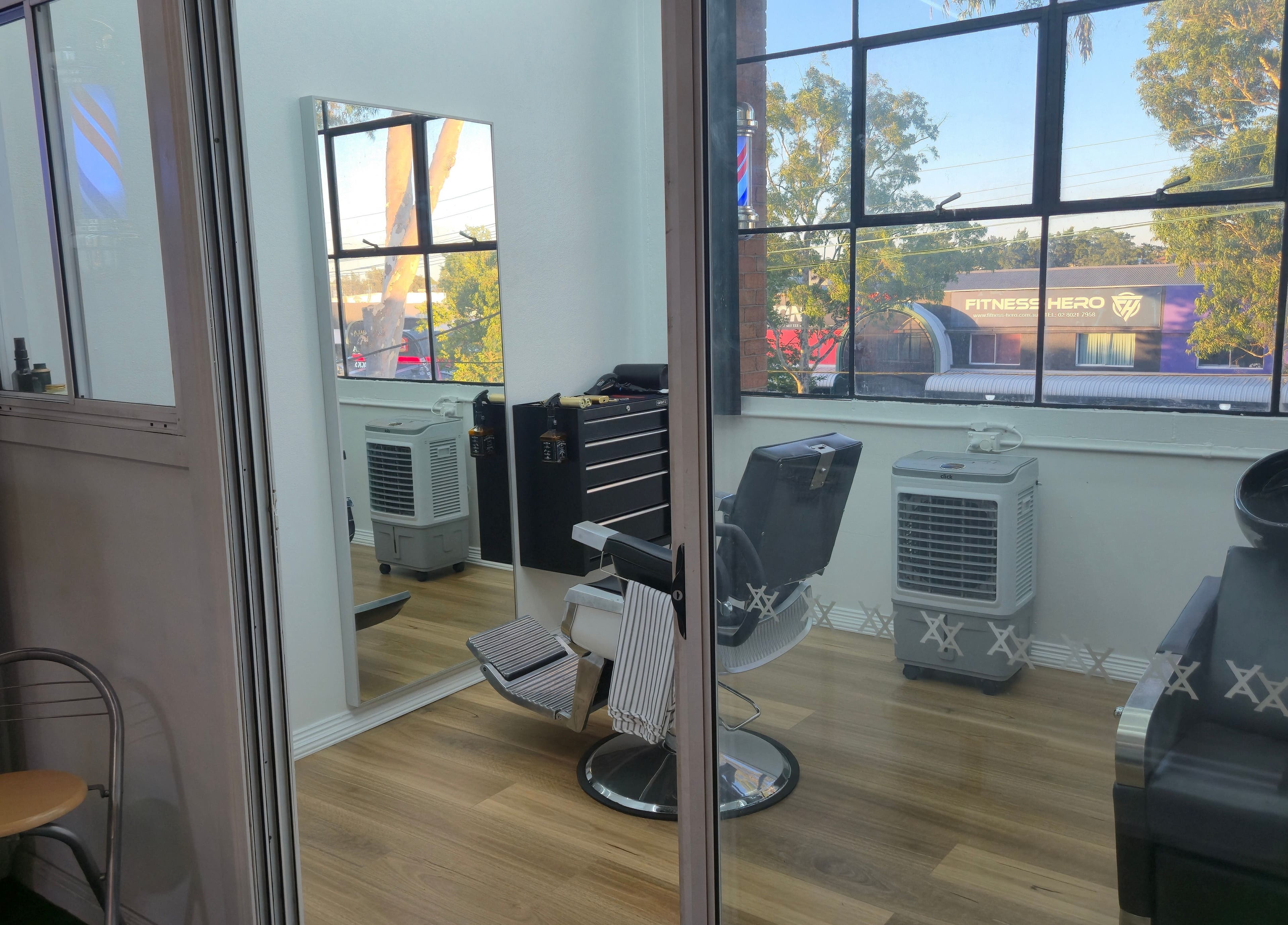 Cozy barber chair in bright room at Midnight Barber Sydney, Bankstown, New South Wales, AU with large windows.