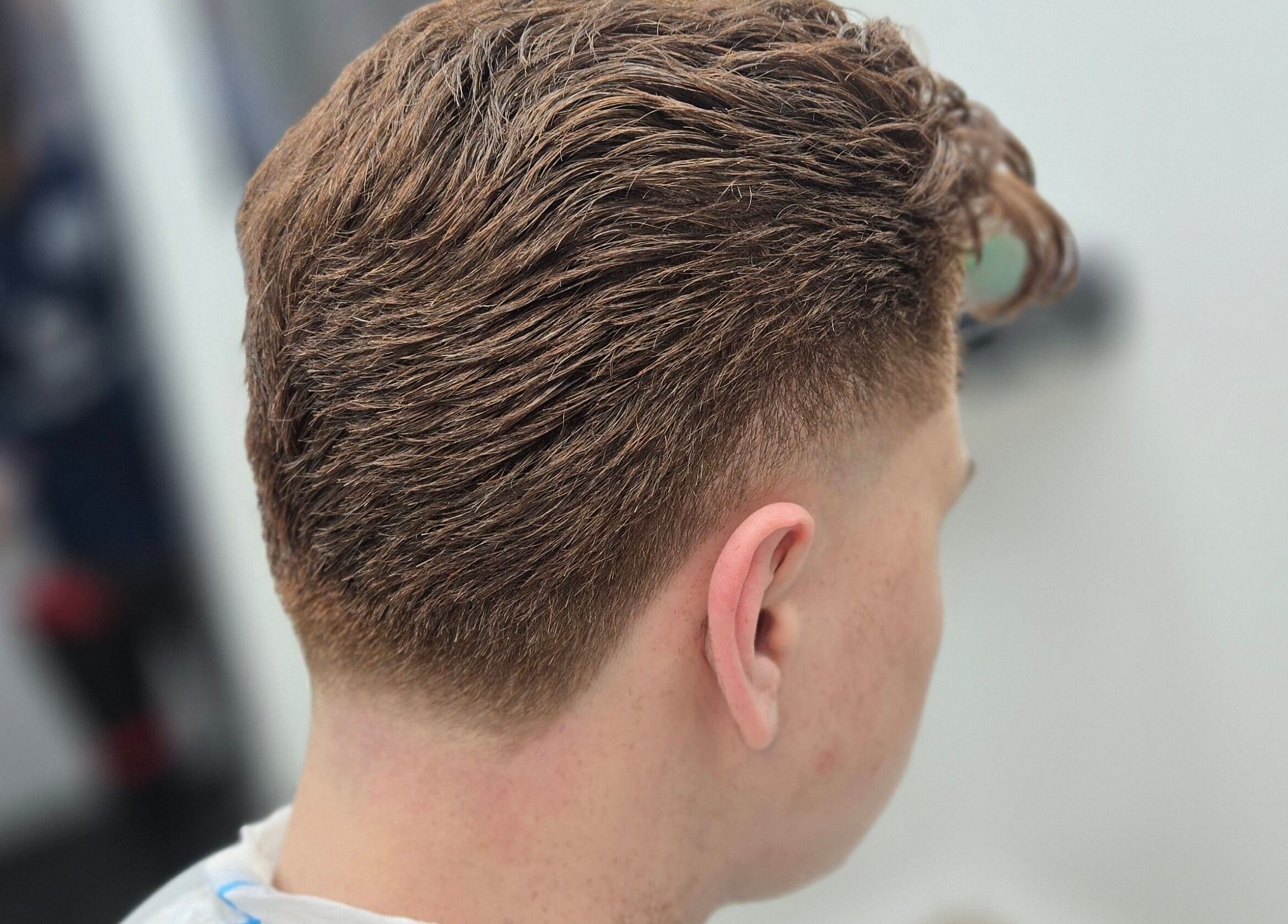 Precision haircut at Midnight Barber Sydney in Bankstown, New South Wales, AU showcasing a stylish fade.