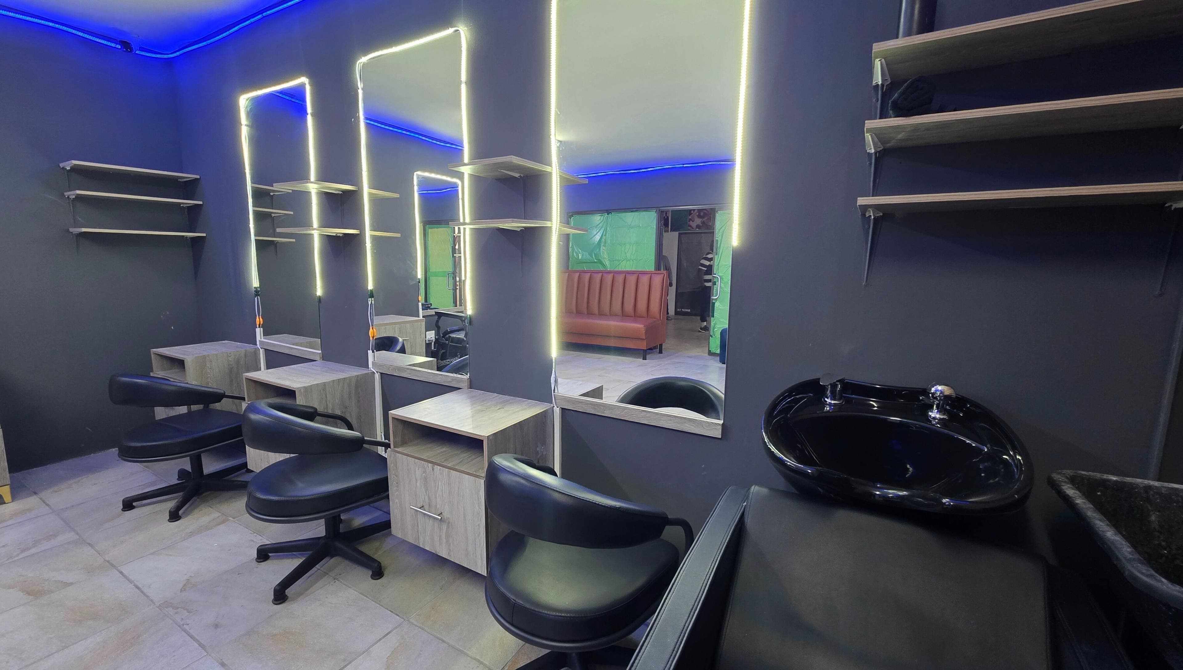 Interior of Dr Barber Hair Salon SA, located in Johannesburg, Gauteng, ZA, featuring modern chairs and mirrors.