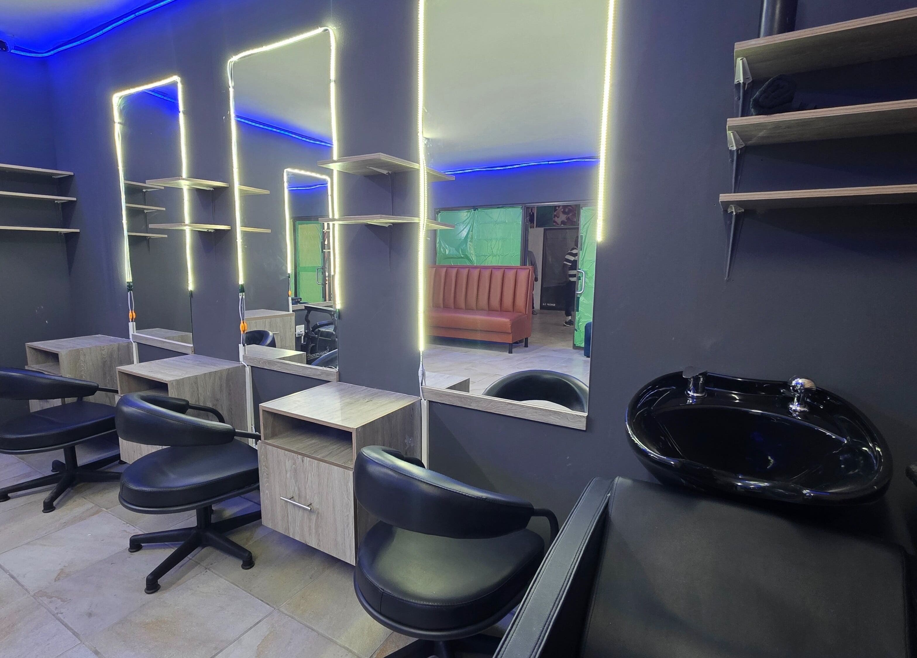 Interior of Dr Barber Hair Salon SA, located in Johannesburg, Gauteng, ZA, featuring modern chairs and mirrors.