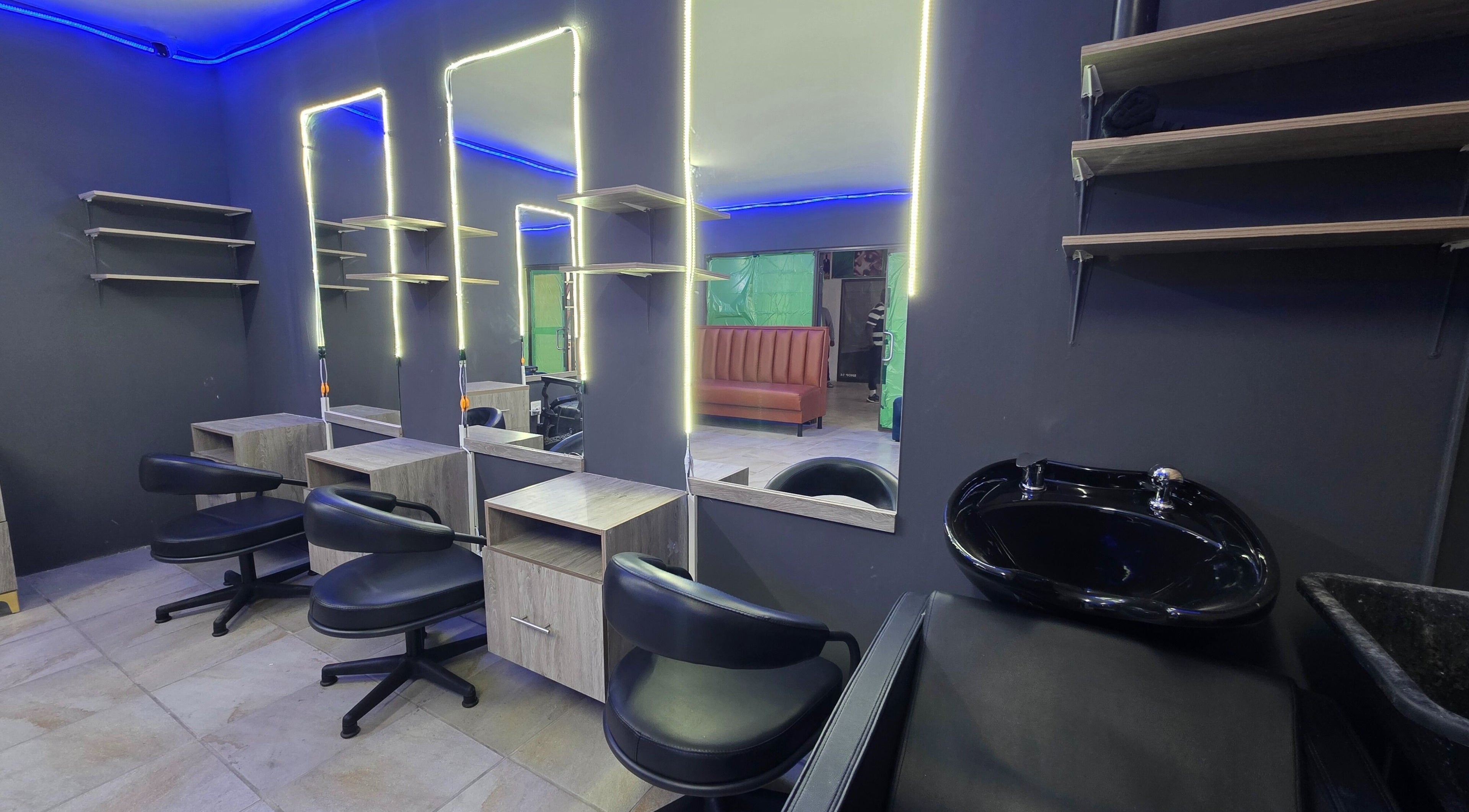 Interior of Dr Barber Hair Salon SA, located in Johannesburg, Gauteng, ZA, featuring modern chairs and mirrors.