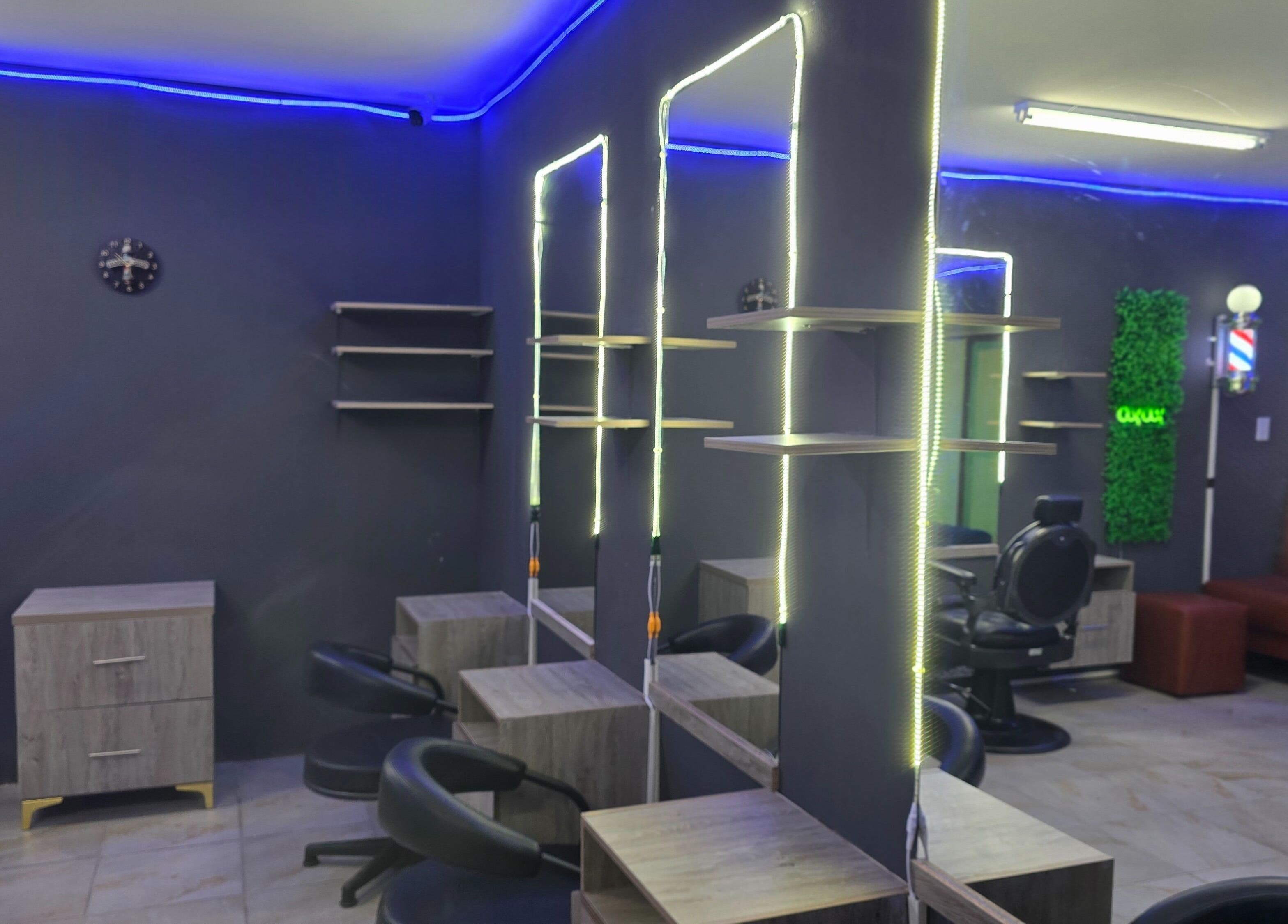 Modern interior of Dr Barber Hair Salon SA, Johannesburg, Gauteng, ZA with sleek stations and stylish lighting.