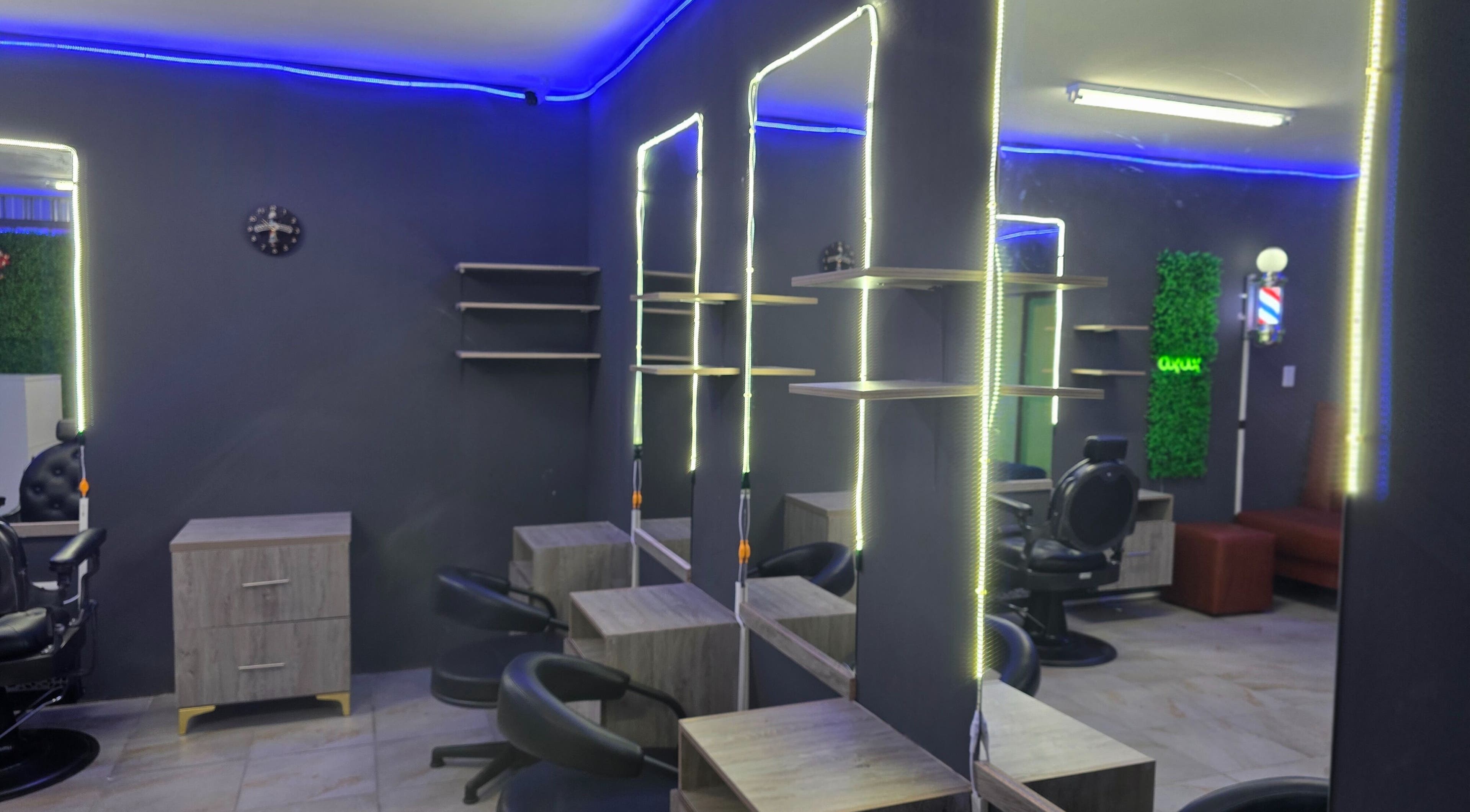 Modern interior of Dr Barber Hair Salon SA in Johannesburg, Gauteng, ZA, with stylish lighting and seating.