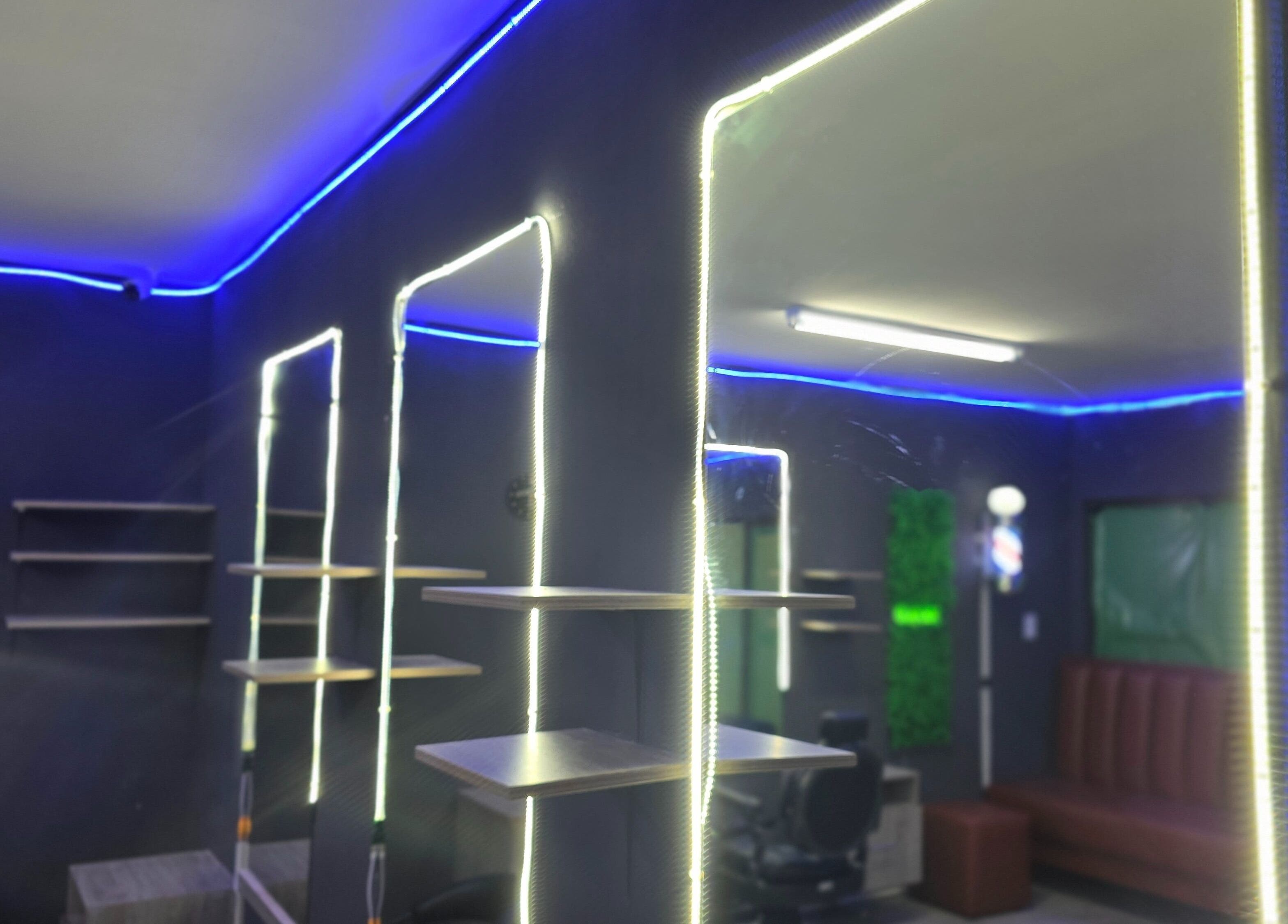Interior of Dr Barber Hair Salon SA, Johannesburg, Gauteng, ZA with modern shelving and vibrant lighting.