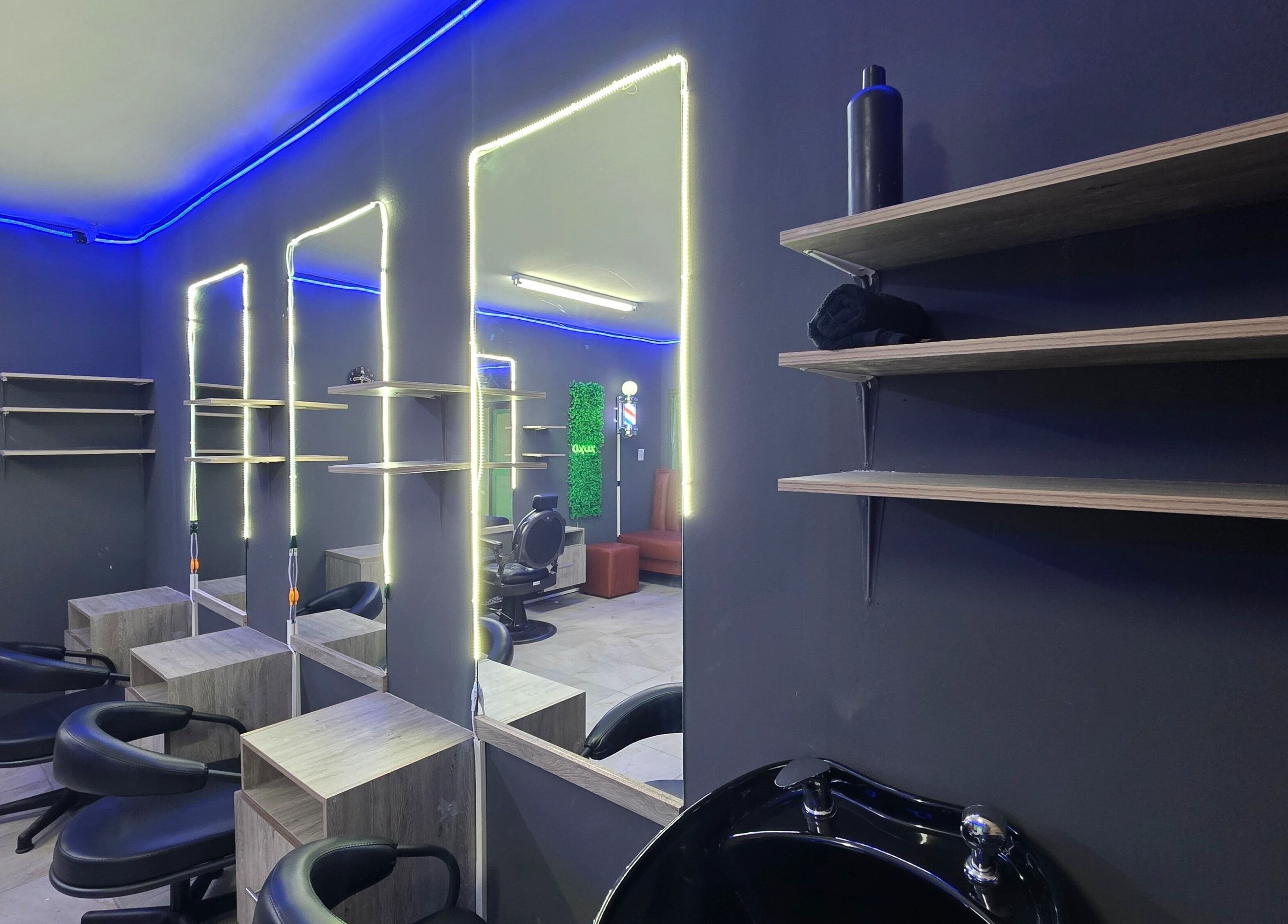 Chic interior of Dr Barber Hair Salon SA in Johannesburg, Gauteng, ZA with mirrored stations and modern lighting.