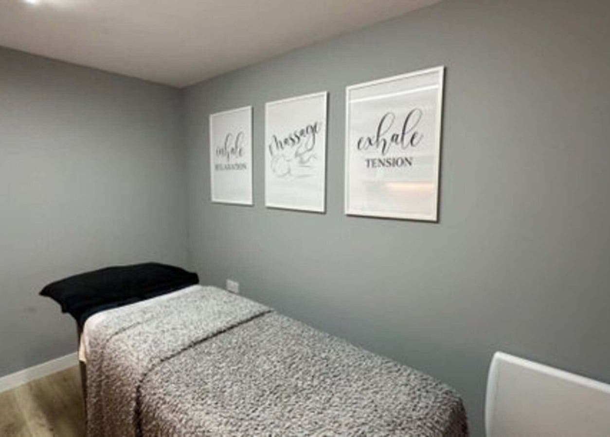 Calm treatment room in Elle Aesthetic, London, England, GB with soothing wall art and massage bed.