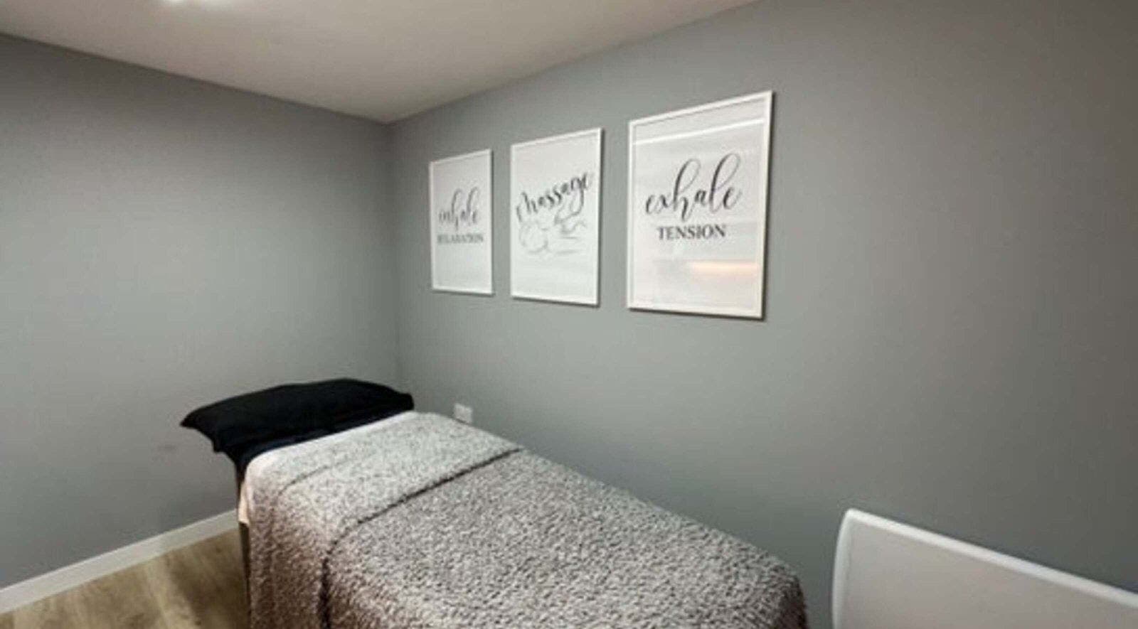 Calm treatment room in Elle Aesthetic, London, England, GB with soothing wall art and massage bed.