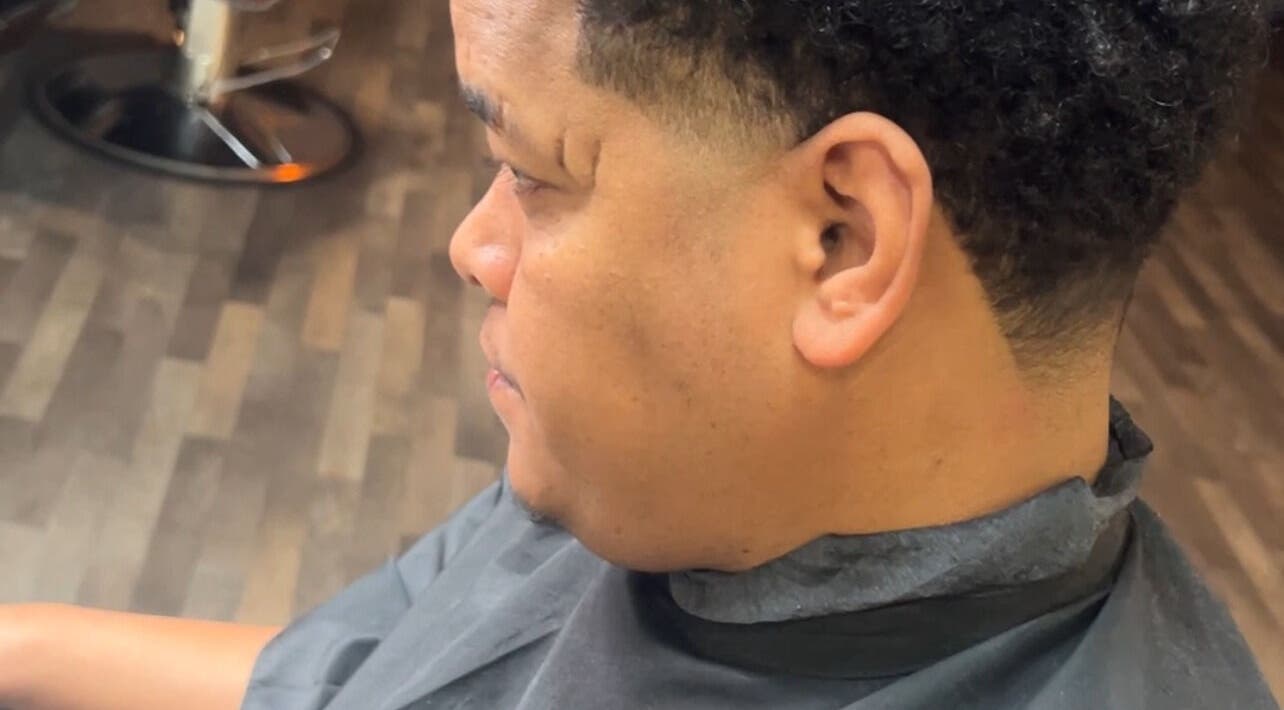 Fresh fade haircut at Hall Of Fades in Manchester, England, GB with smooth finish.