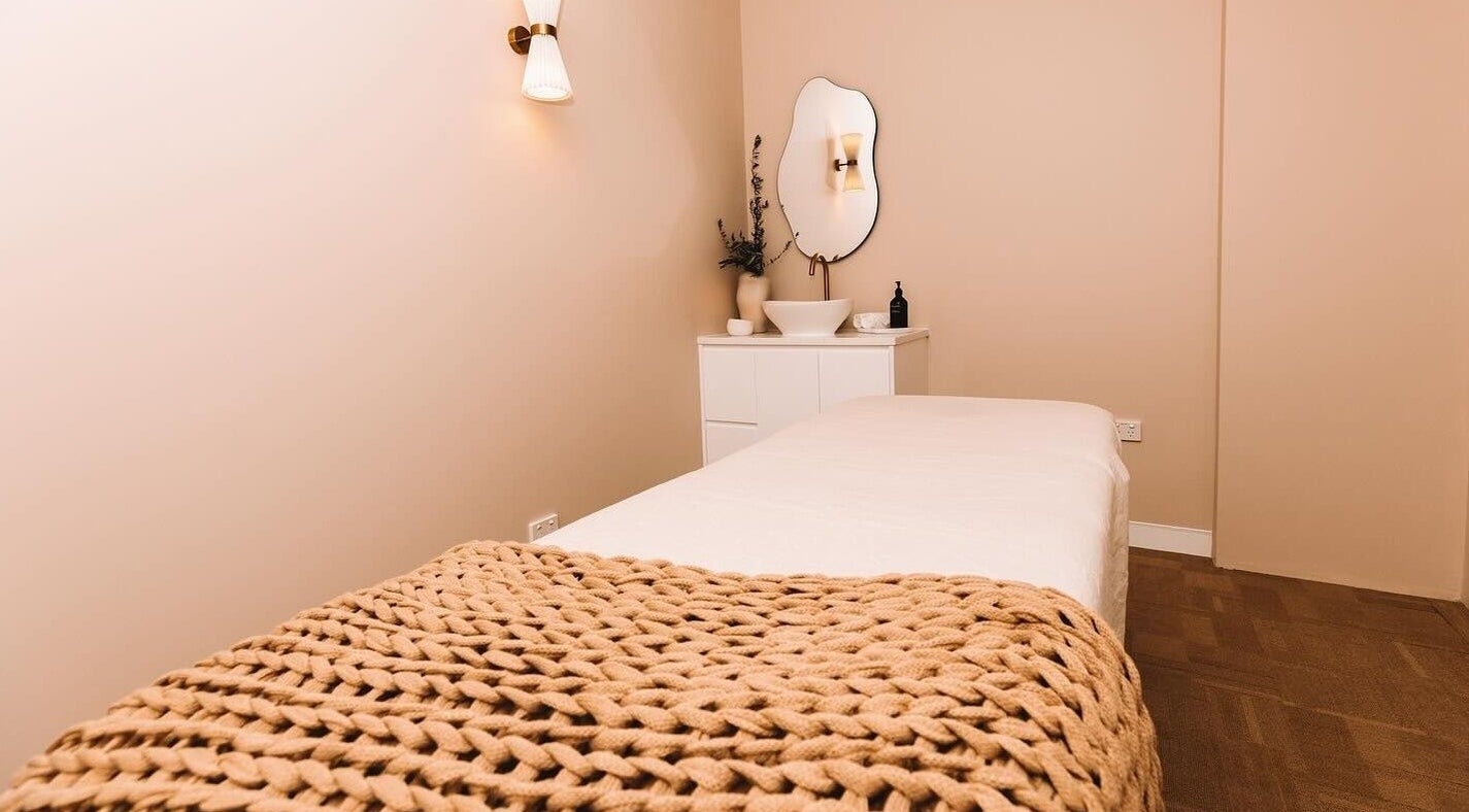 Serene massage room at Atma Wellbeing, Dee Why, New South Wales, AU with cozy blanket.