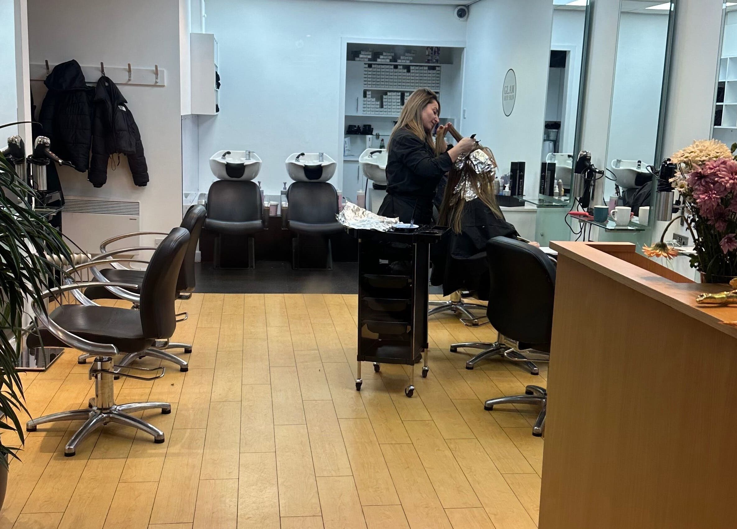 Glam Hair Salon in Bolton, England, GB, showcasing modern styling stations and professional hair treatment.