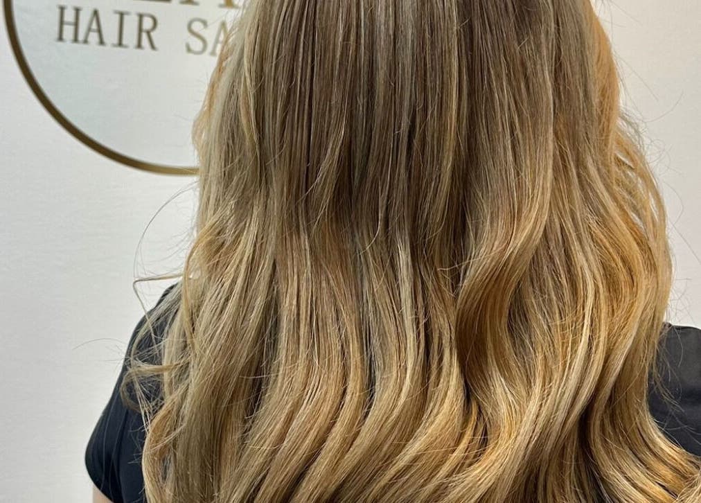 Elegant blonde waves styled at Glam Hair Salon, Bolton, England, GB. Perfect for a glamorous and chic look.