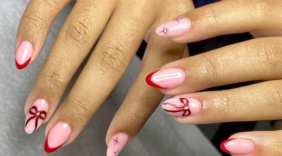 Elegant red-tipped nails with bow designs at Polish by Lisa, Paramaribo, Paramaribo, SR.