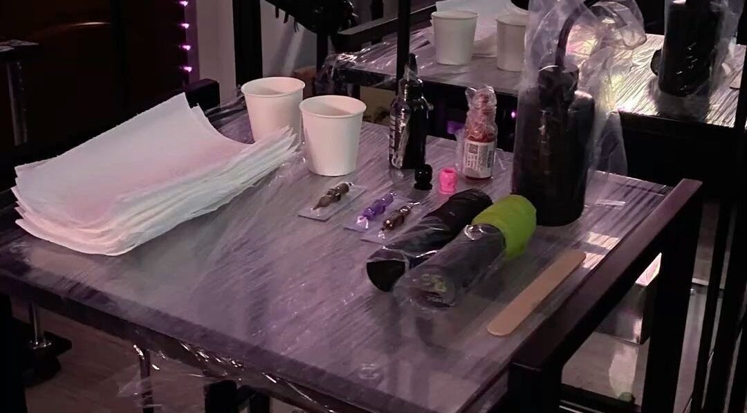 Tattoo equipment setup at Lokaine Beauty, Charlotte, North Carolina, US showcasing tools and hygiene products.