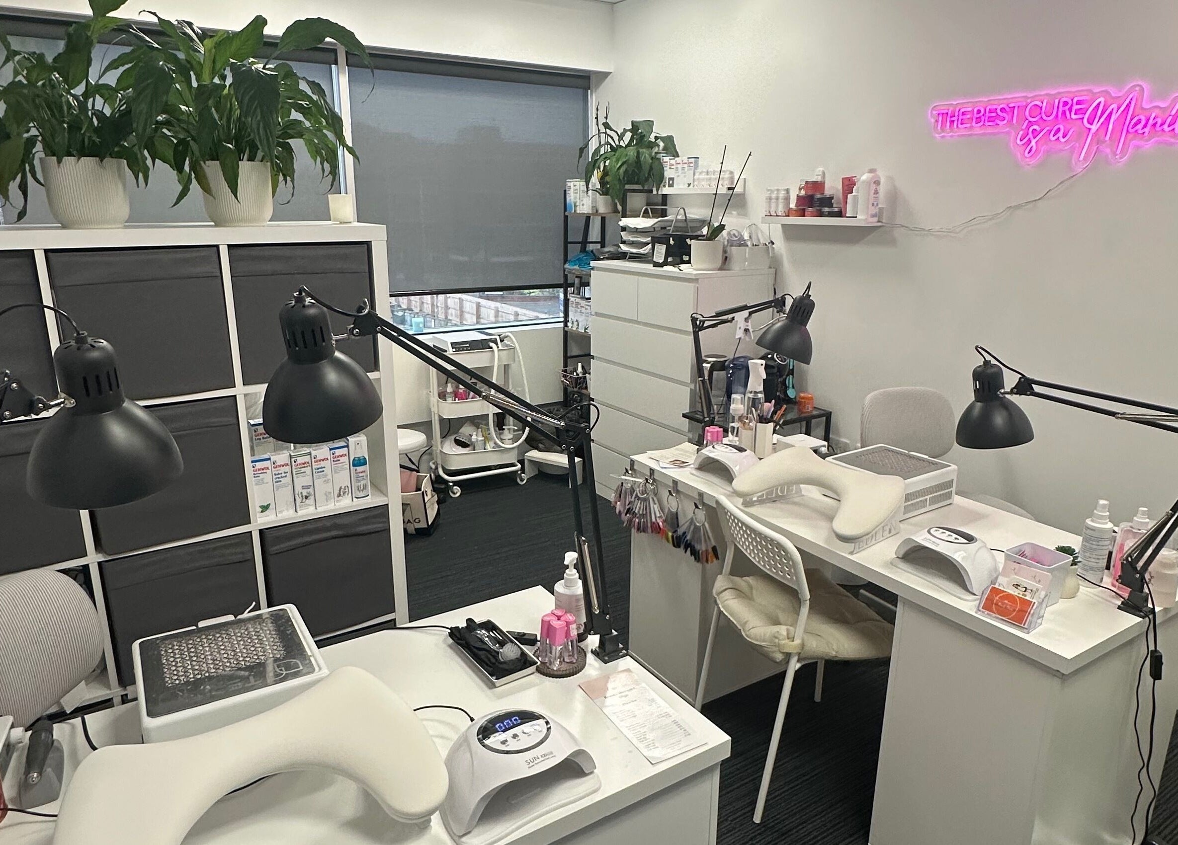 Modern manicure area at Mango Beauty Studio, Woking, England, GB, featuring stylish workstations and decor.