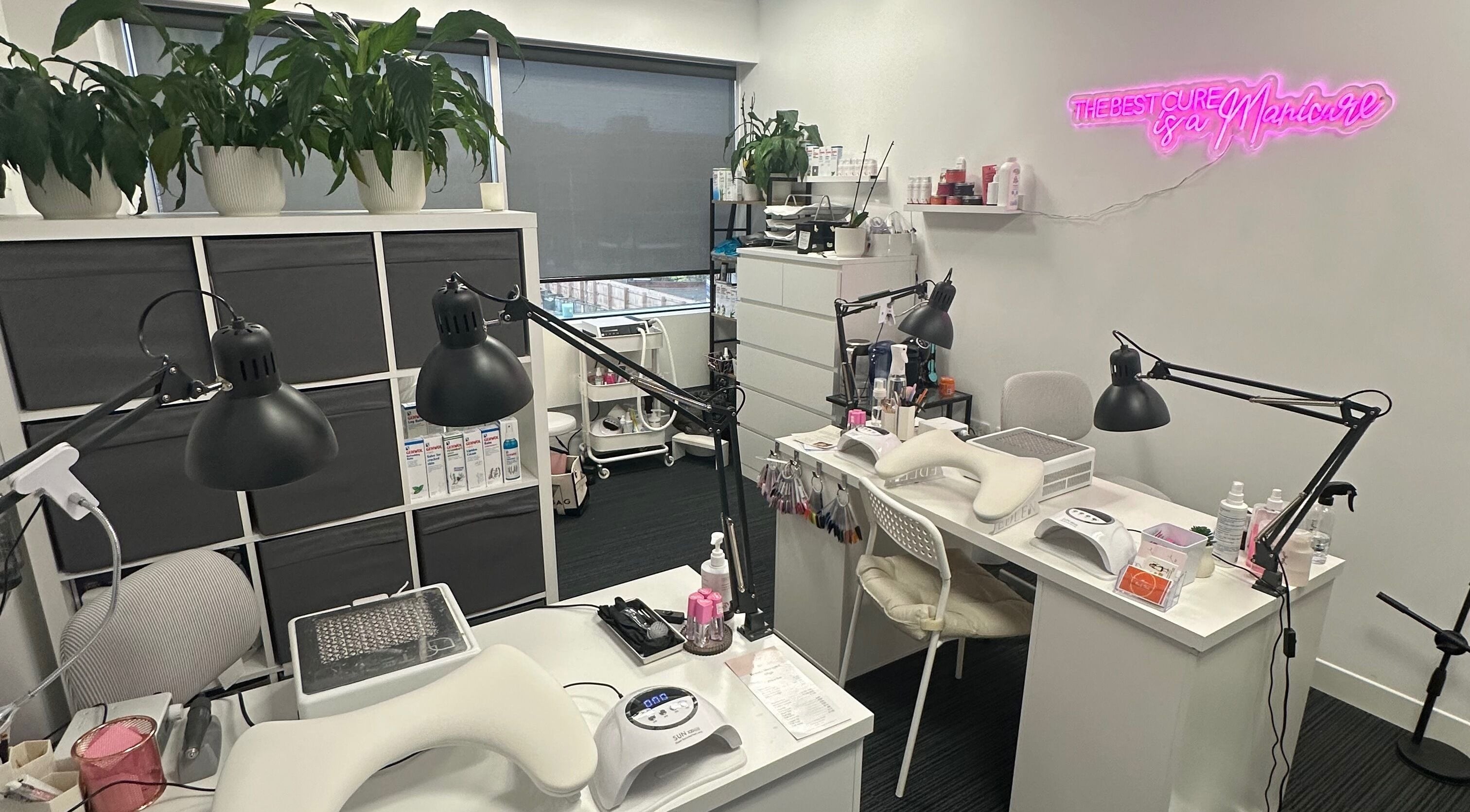 Modern manicure area at Mango Beauty Studio, Woking, England, GB, featuring stylish workstations and decor.