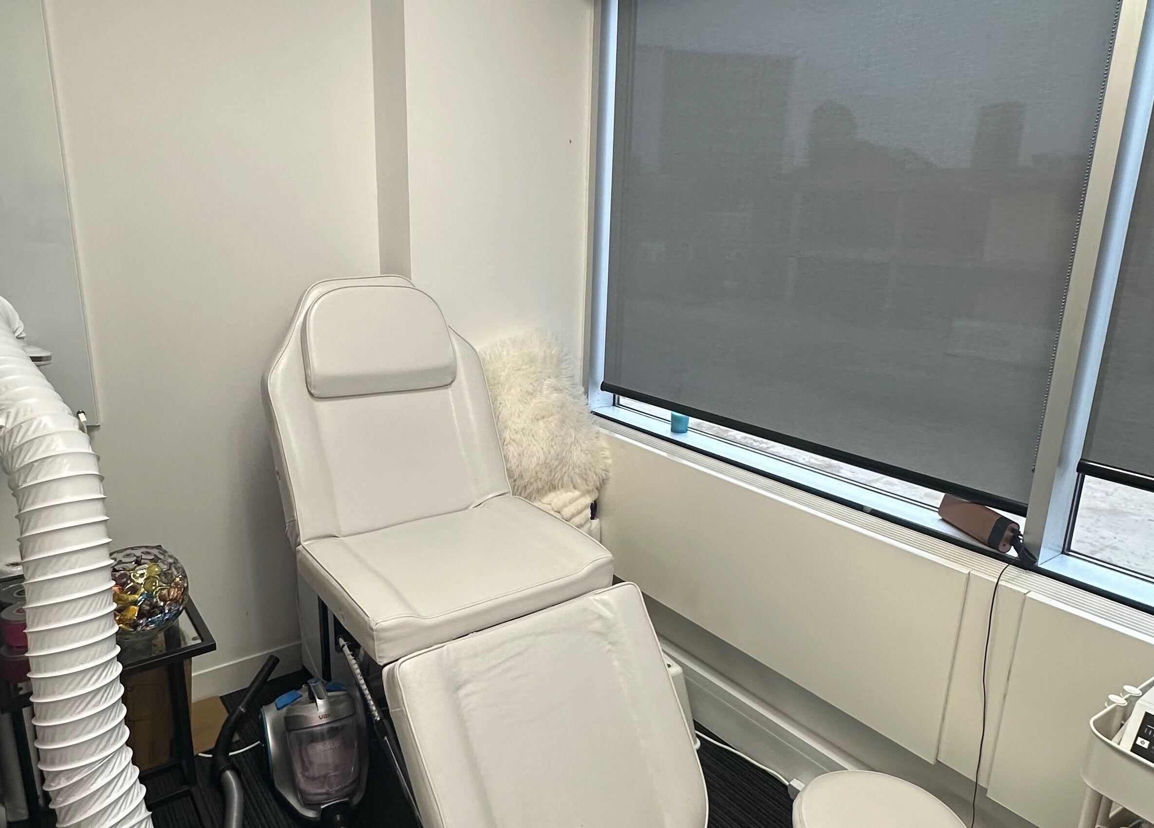 Cozy treatment room at Mango Beauty Studio, Woking, England, GB, featuring a plush white recliner.