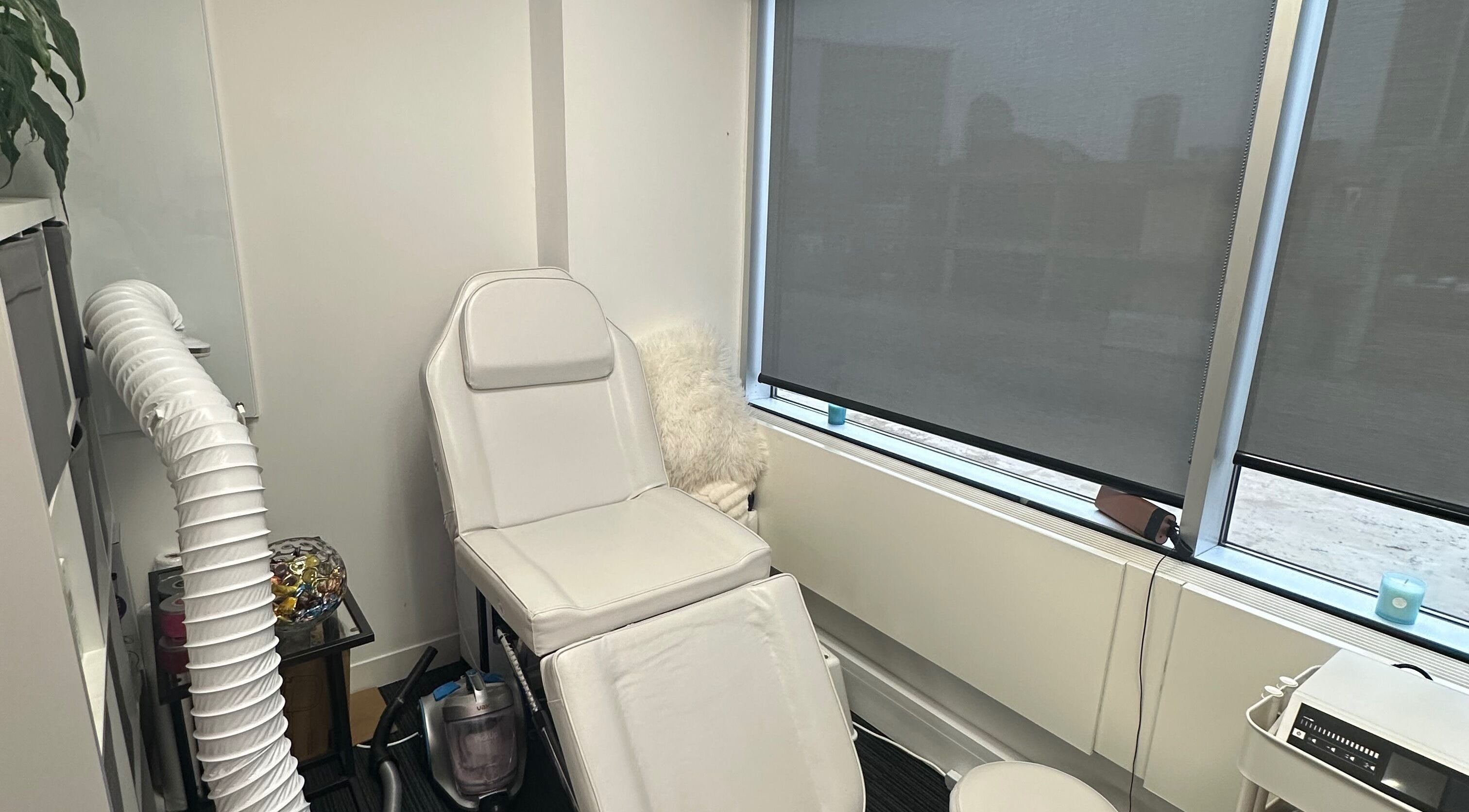 Cozy treatment room at Mango Beauty Studio, Woking, England, GB, featuring a plush white recliner.