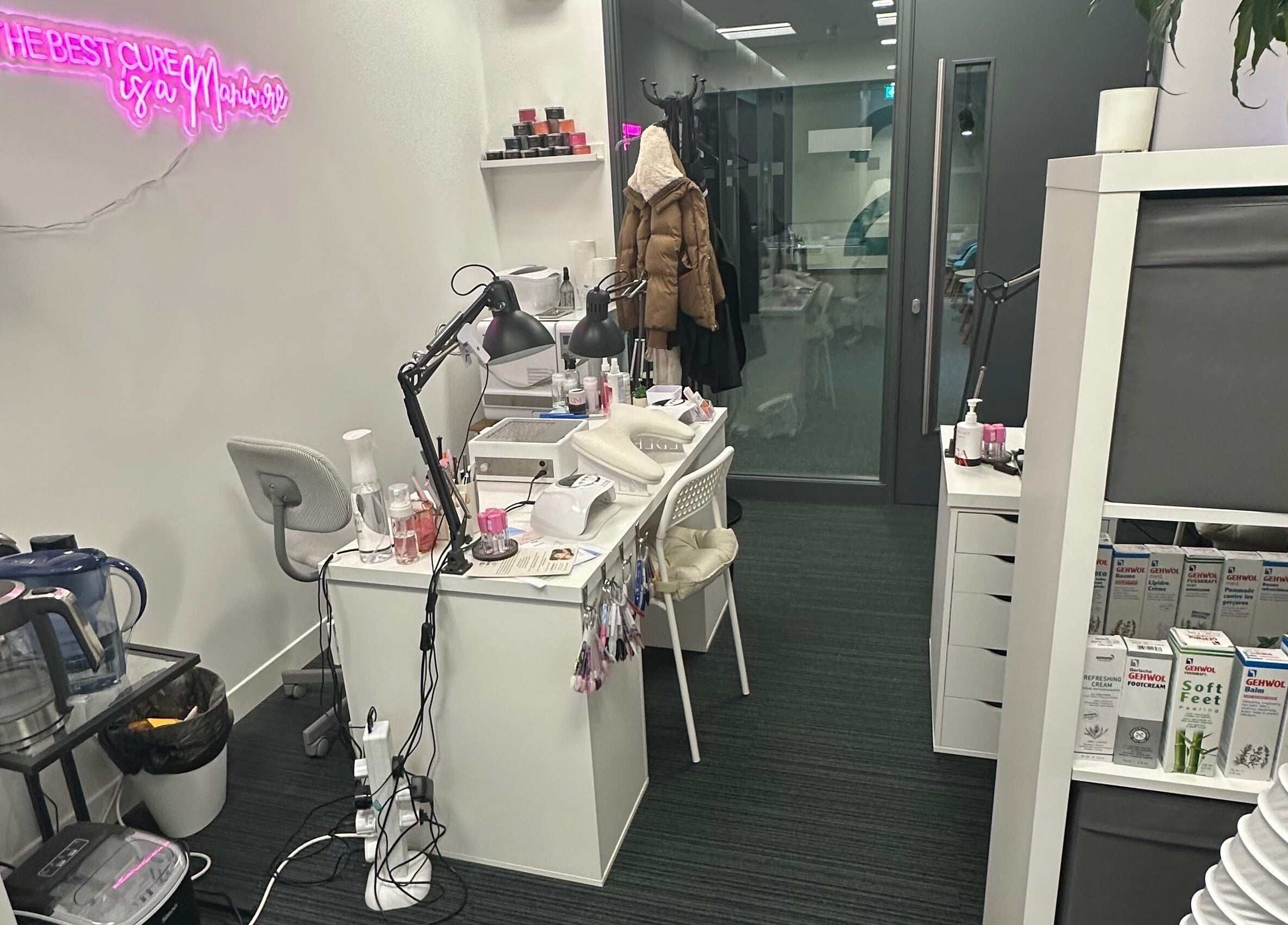 Cozy nail station at Mango Beauty Studio in Woking, England, GB, with stylish decor and beauty products.