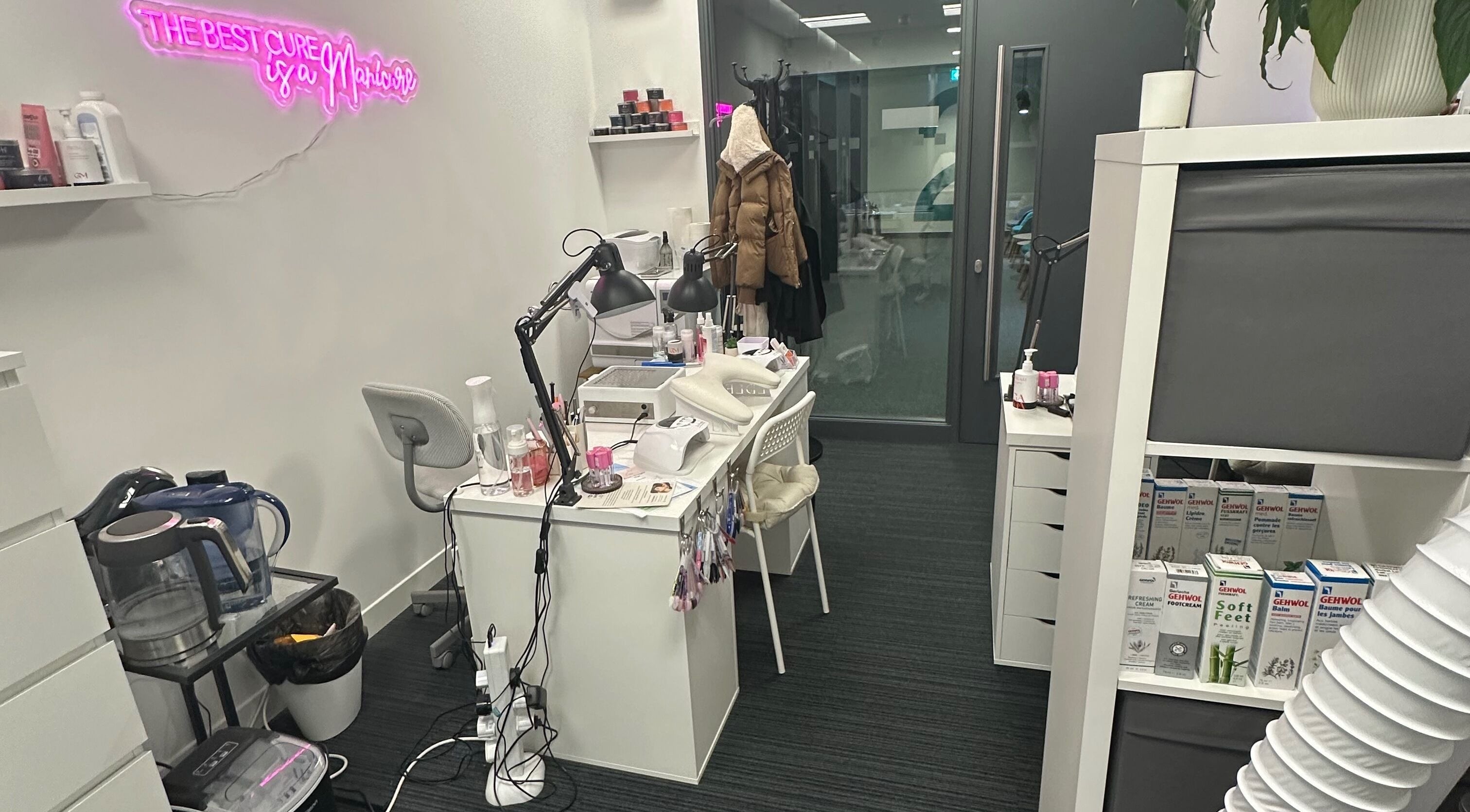 Cozy nail station at Mango Beauty Studio in Woking, England, GB, with stylish decor and beauty products.
