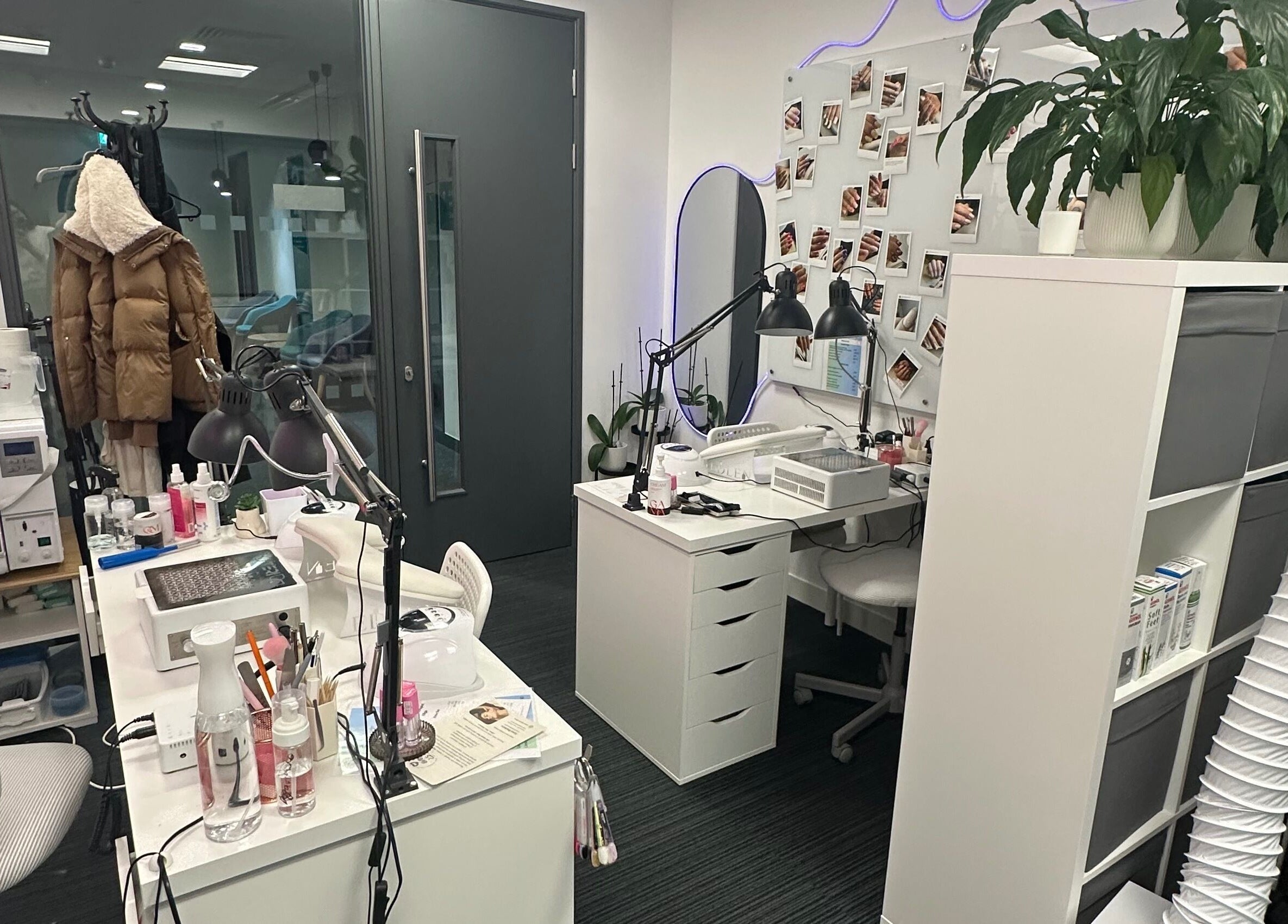 Cozy interior of Mango Beauty Studio in Woking, England, GB, featuring nail stations with organized beauty tools.