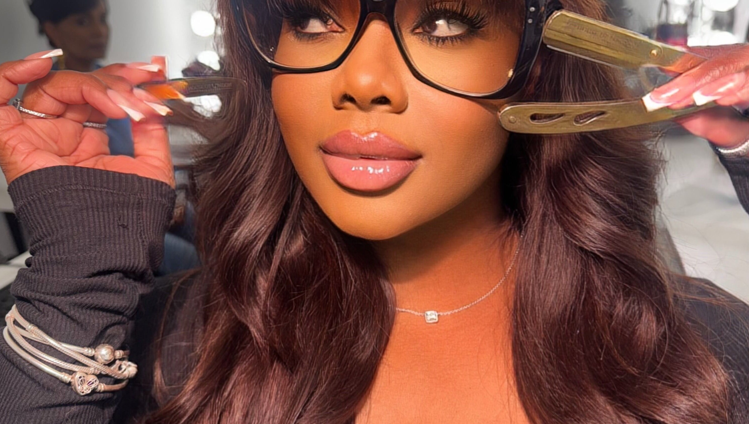 Woman in glasses getting hair styled at House Of London Bahamas, Nassau, New Providence, BS.