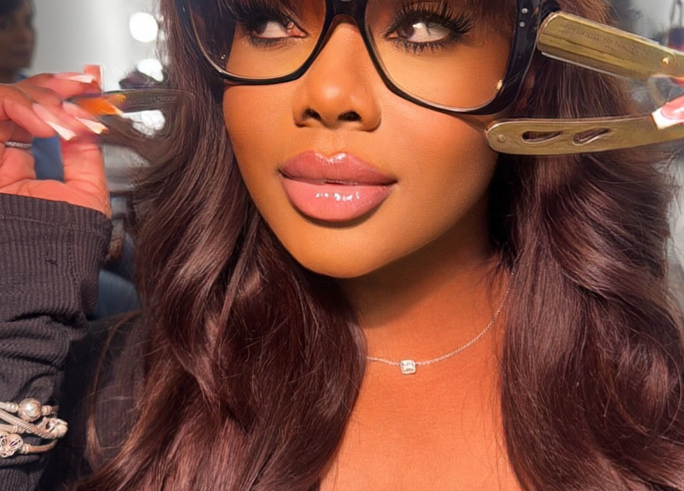 Woman in glasses getting hair styled at House Of London Bahamas, Nassau, New Providence, BS.