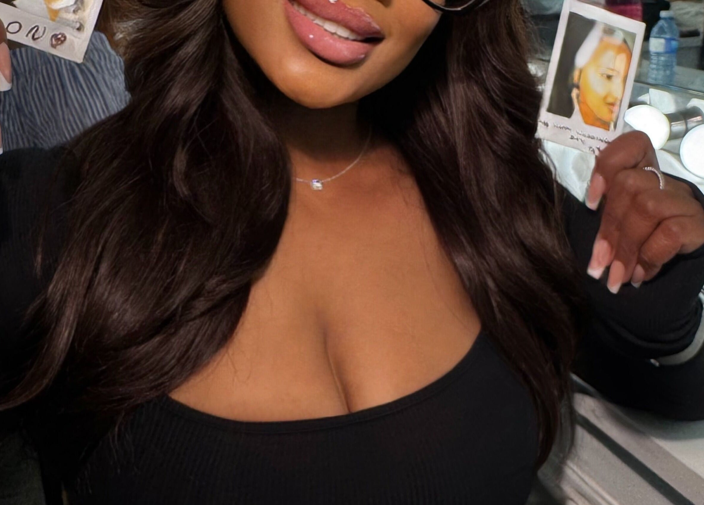 Stylish woman holding photos at House Of London Bahamas, Nassau, New Providence, BS.