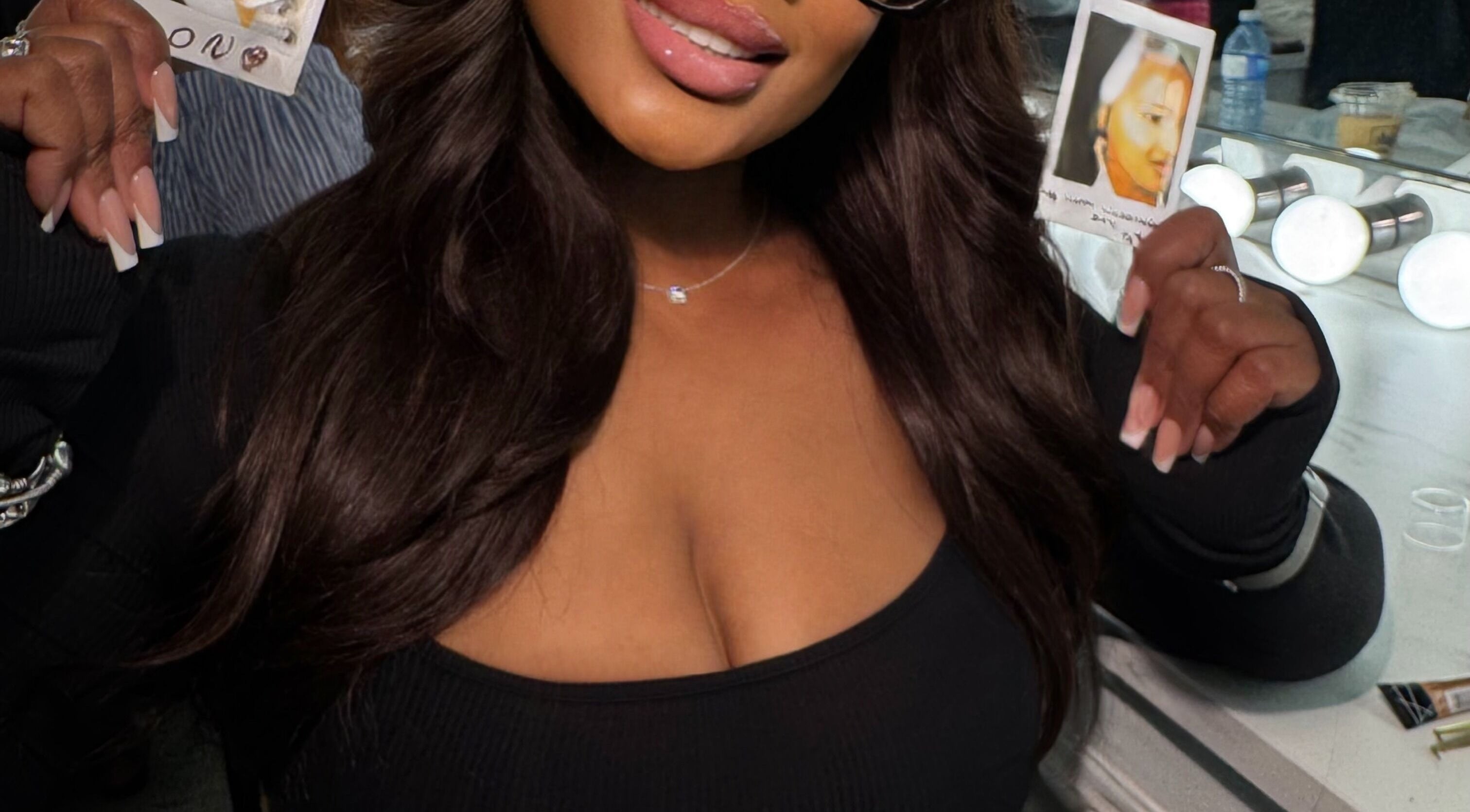 Stylish woman holding photos at House Of London Bahamas, Nassau, New Providence, BS.