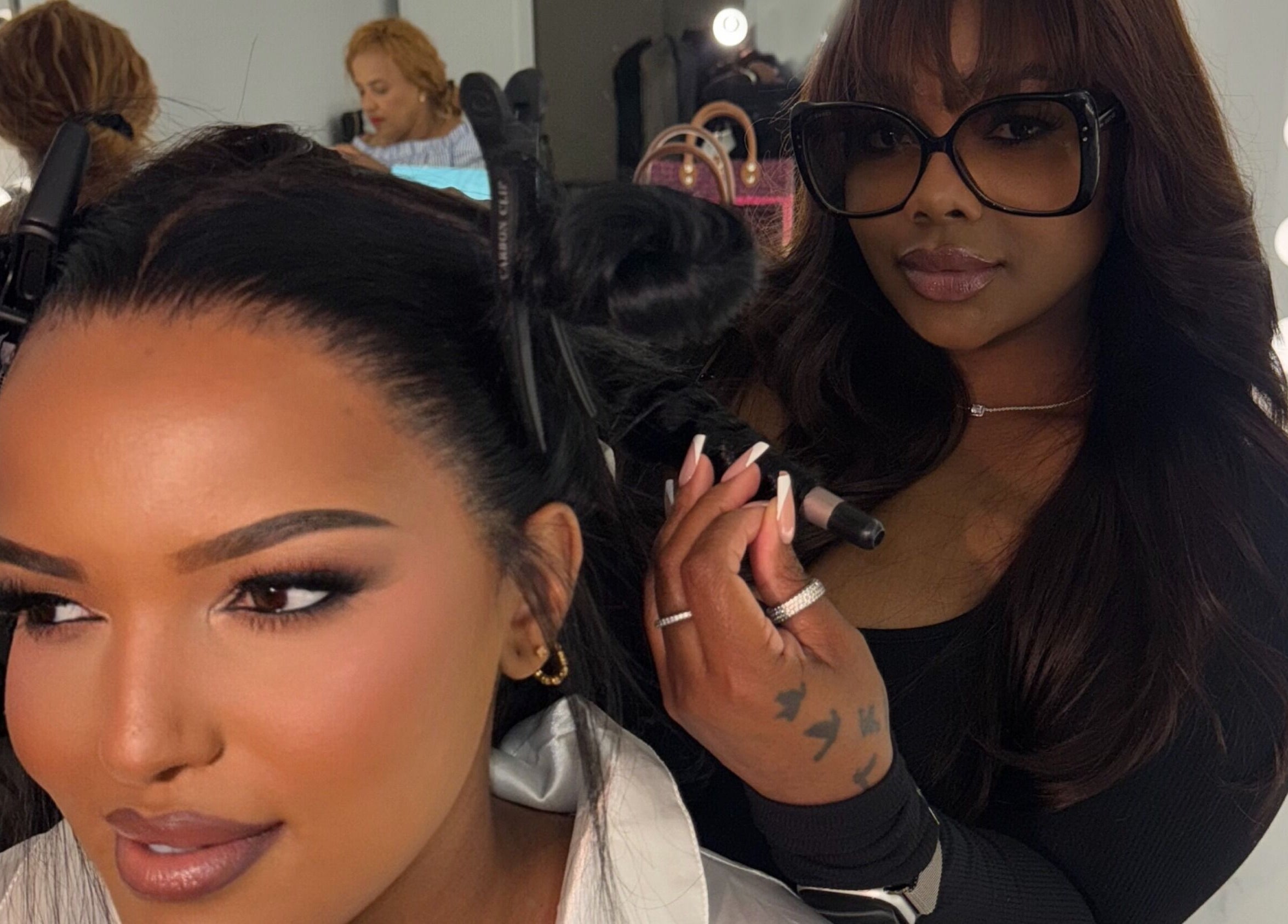 Professional stylist curling hair at House Of London Bahamas, Nassau, New Providence, BS.