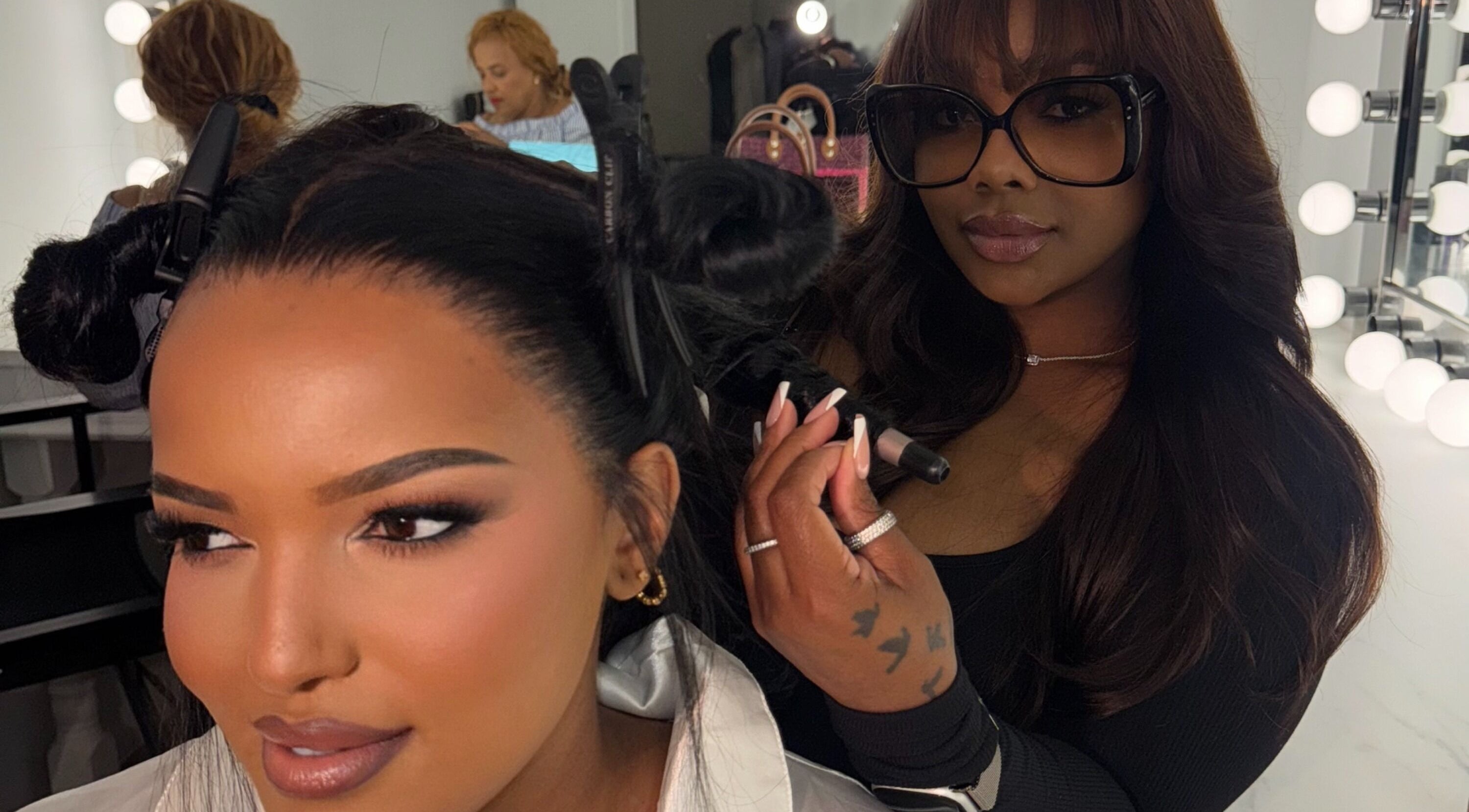 Professional stylist curling hair at House Of London Bahamas, Nassau, New Providence, BS.