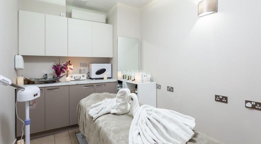 Relaxing treatment room at Enhance Angel Hair & Beauty, London, England, GB with neatly arranged towels.