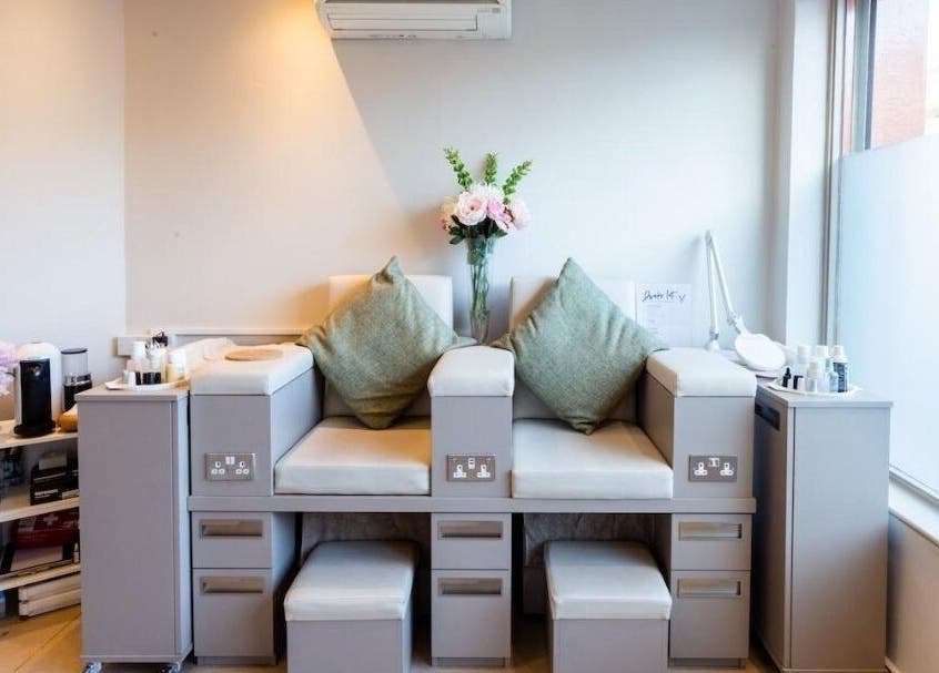 Cozy seating area at Enhance Angel Hair & Beauty, London, England, GB, with plush cushions and soft lighting.