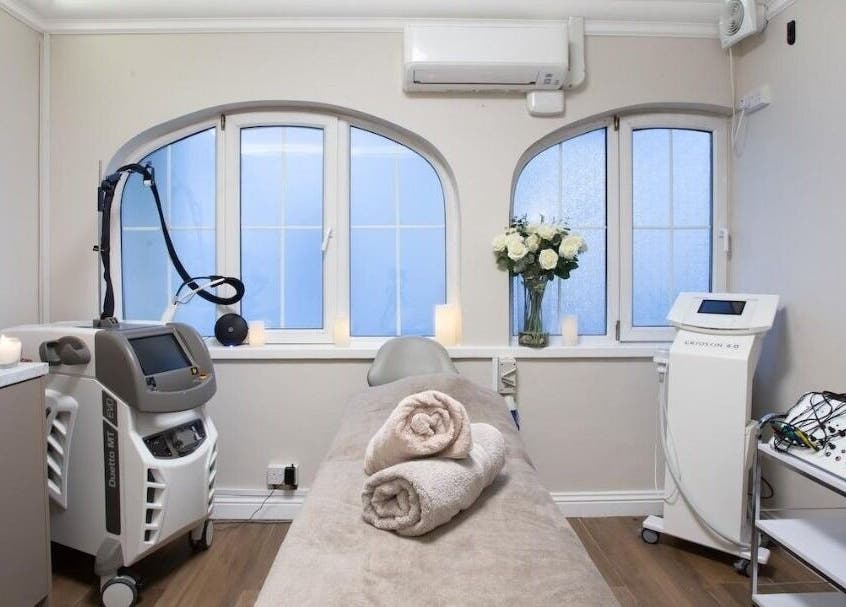 Calm treatment room at Enhance Angel Hair & Beauty, London, England, GB, featuring spa equipment and decor.