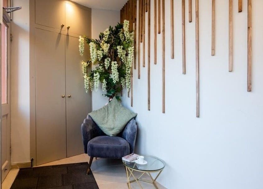 Cozy seating area in Enhance Angel Hair & Beauty, London, England, GB with plush chair and decor.