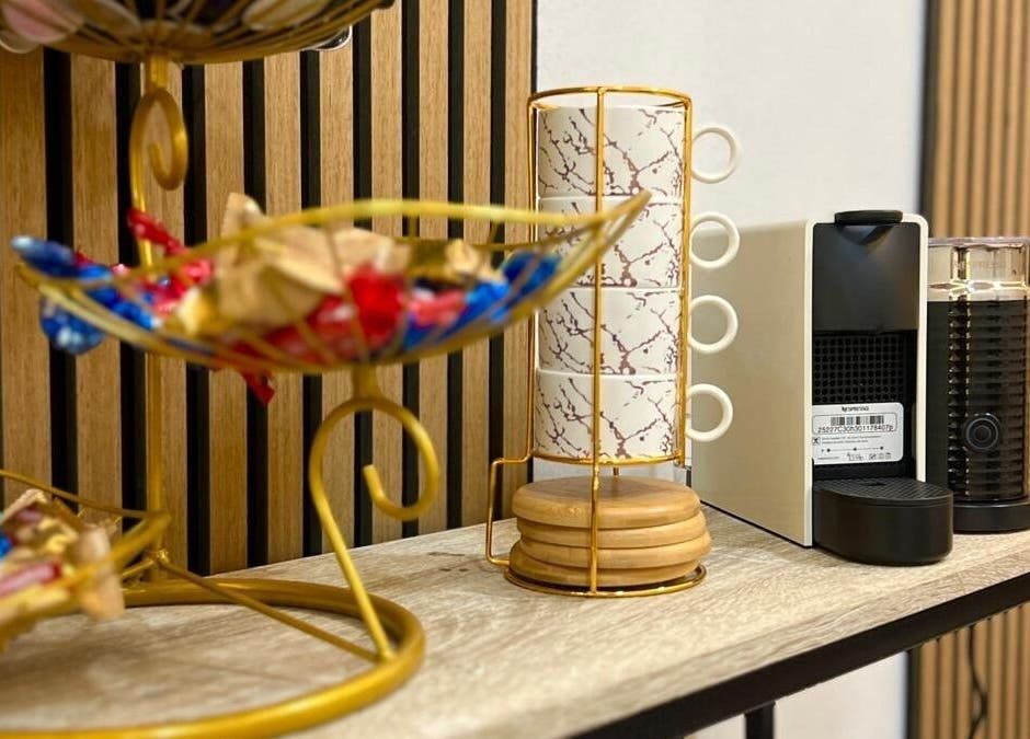 Elegant coffee station at Bluma Nail Bar, Tas-sliema, MT with gold rack and espresso machine.