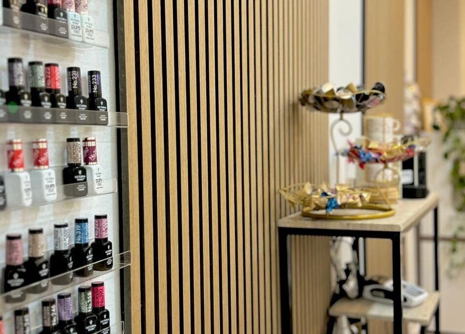 Nail polish display at Bluma Nail Bar, Tas-sliema, MT, showing a range of vibrant colors and chic decor.