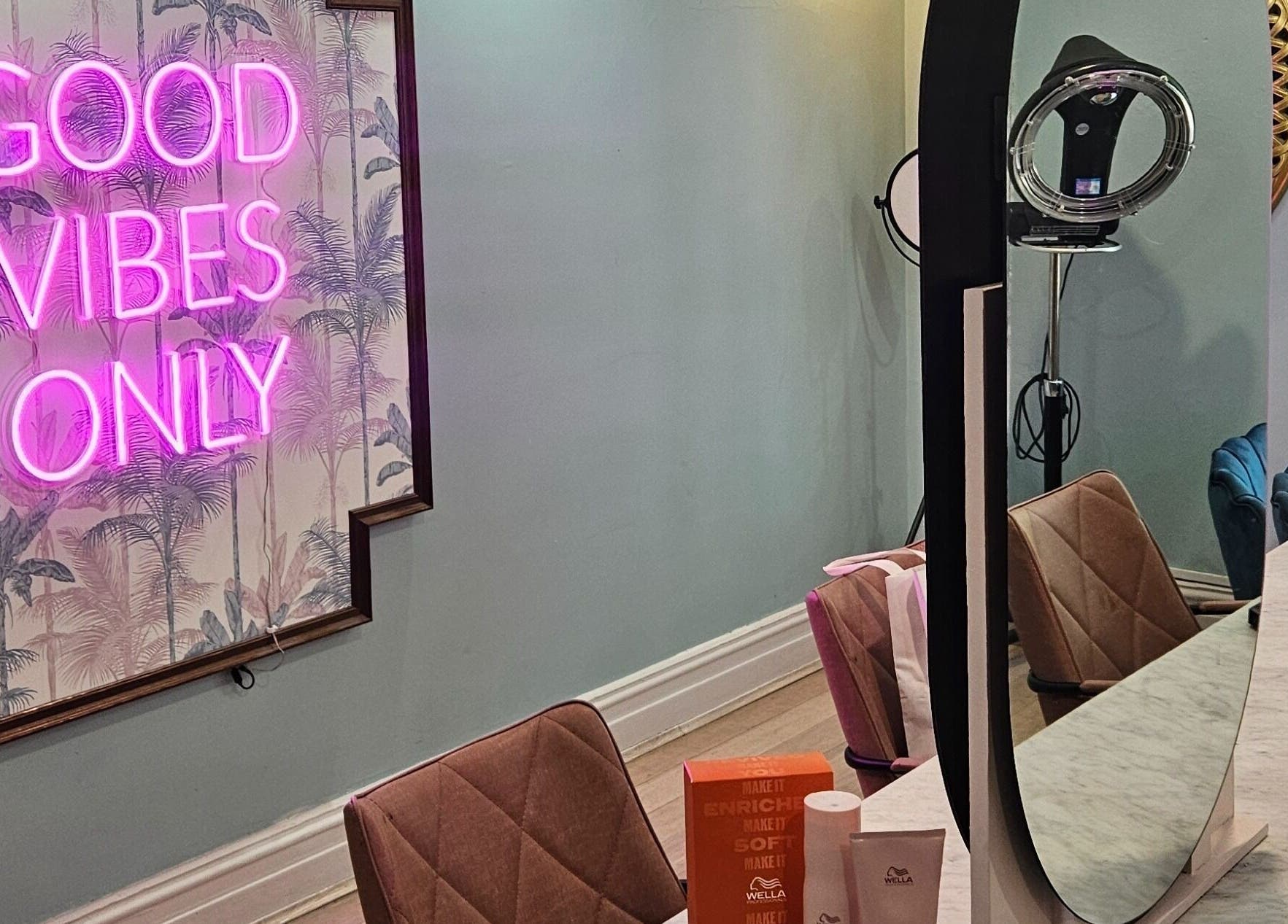 Modern salon interior at Movement not just hair, Surry Hills, New South Wales, AU with neon sign 'Good Vibes Only'.