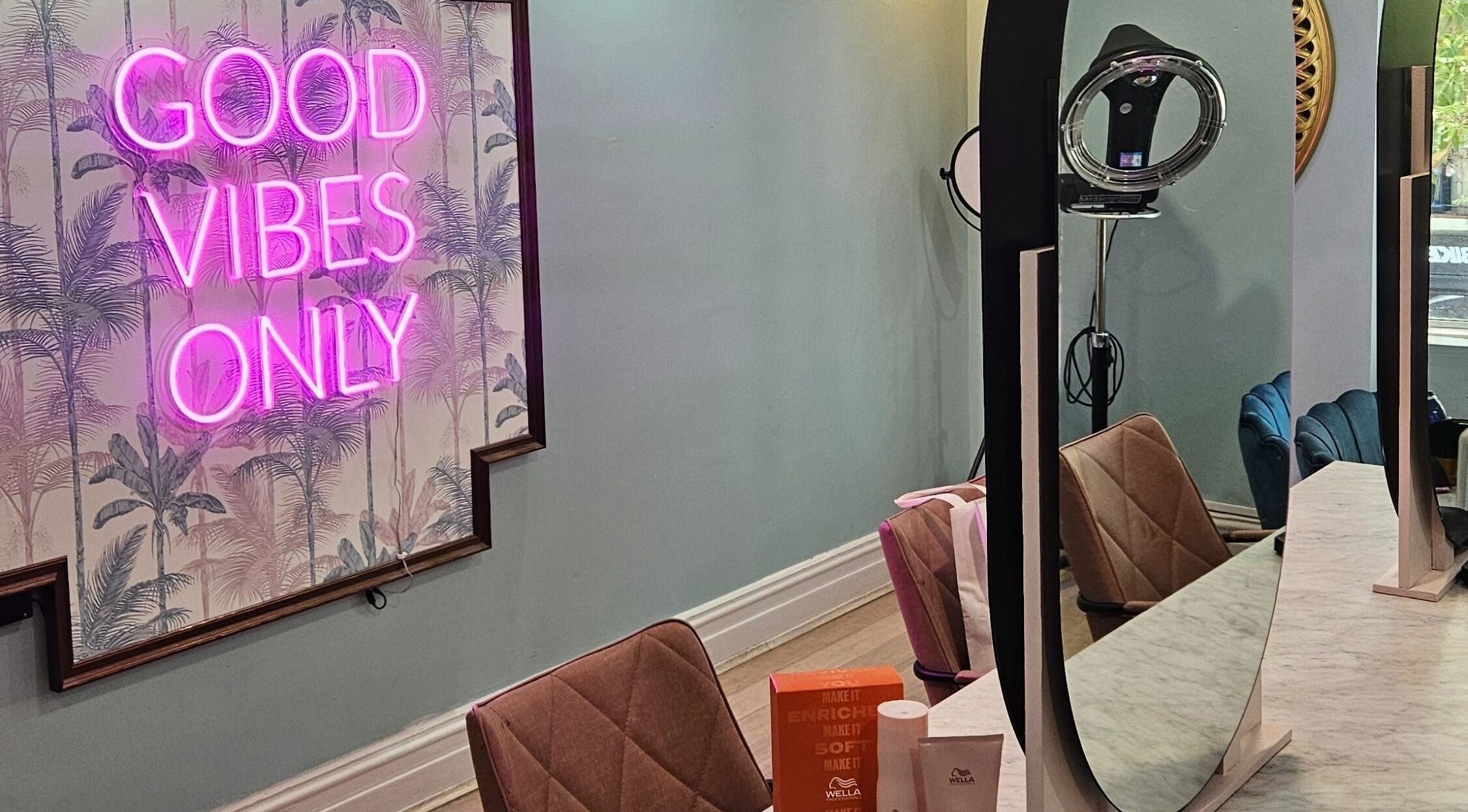 Modern salon interior at Movement not just hair, Surry Hills, New South Wales, AU with neon sign 'Good Vibes Only'.