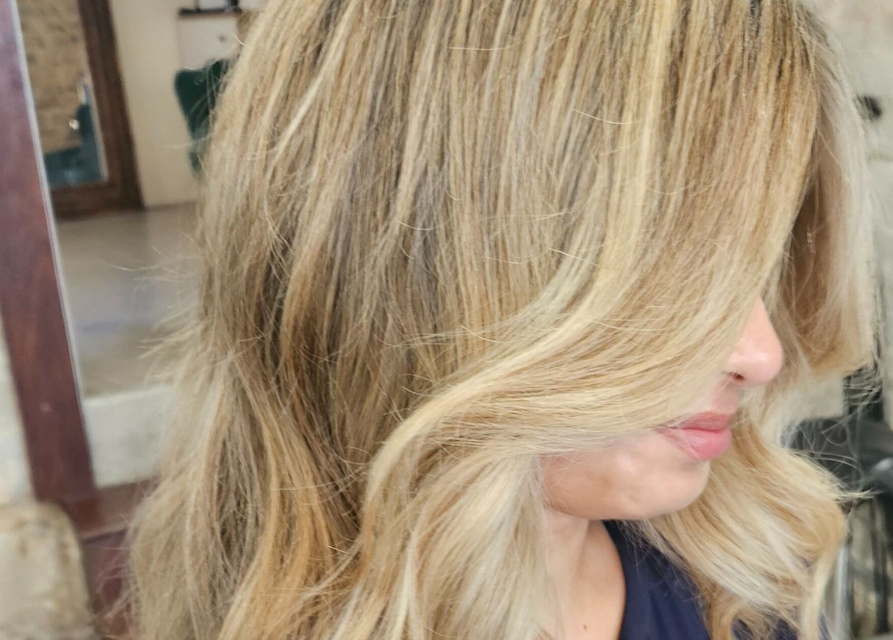 Blonde hair styled in soft waves at Movement Not Just Hair, Surry Hills, New South Wales, AU.