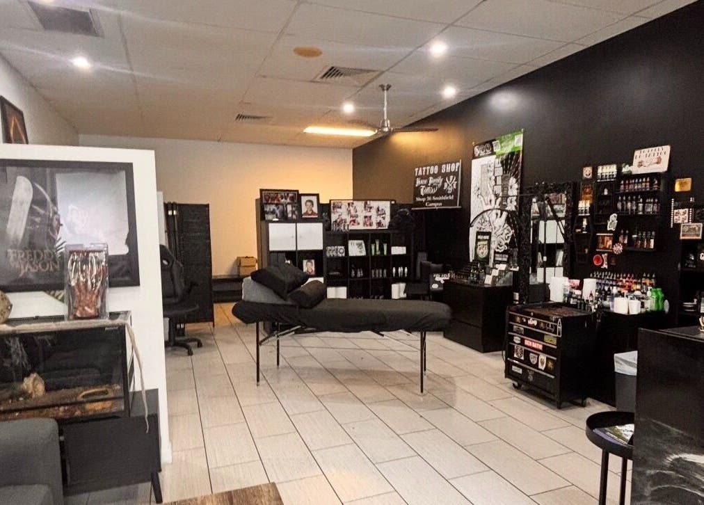 Interior of Skin&stones Body Piercing in Smithfield, Queensland, showcasing a stylish setup and artwork.