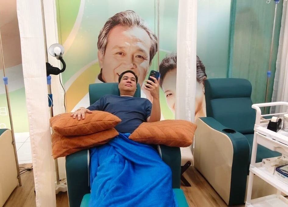 Client enjoying treatment at SkinDrip Clinic - Pasig City, Pasig, Metro Manila, PH in a cozy recliner.