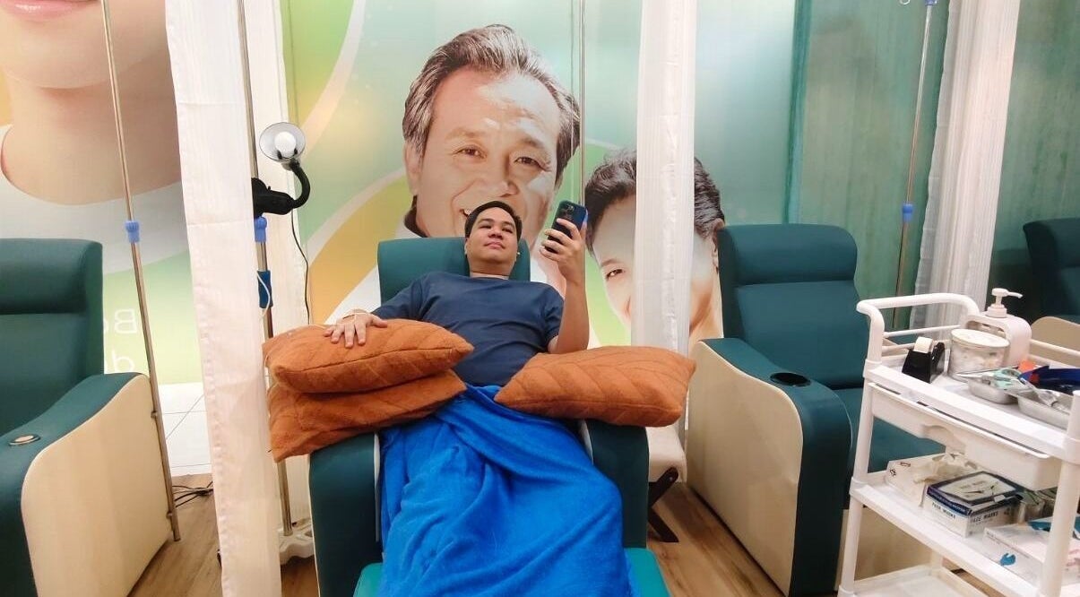 Client enjoying treatment at SkinDrip Clinic - Pasig City, Pasig, Metro Manila, PH in a cozy recliner.