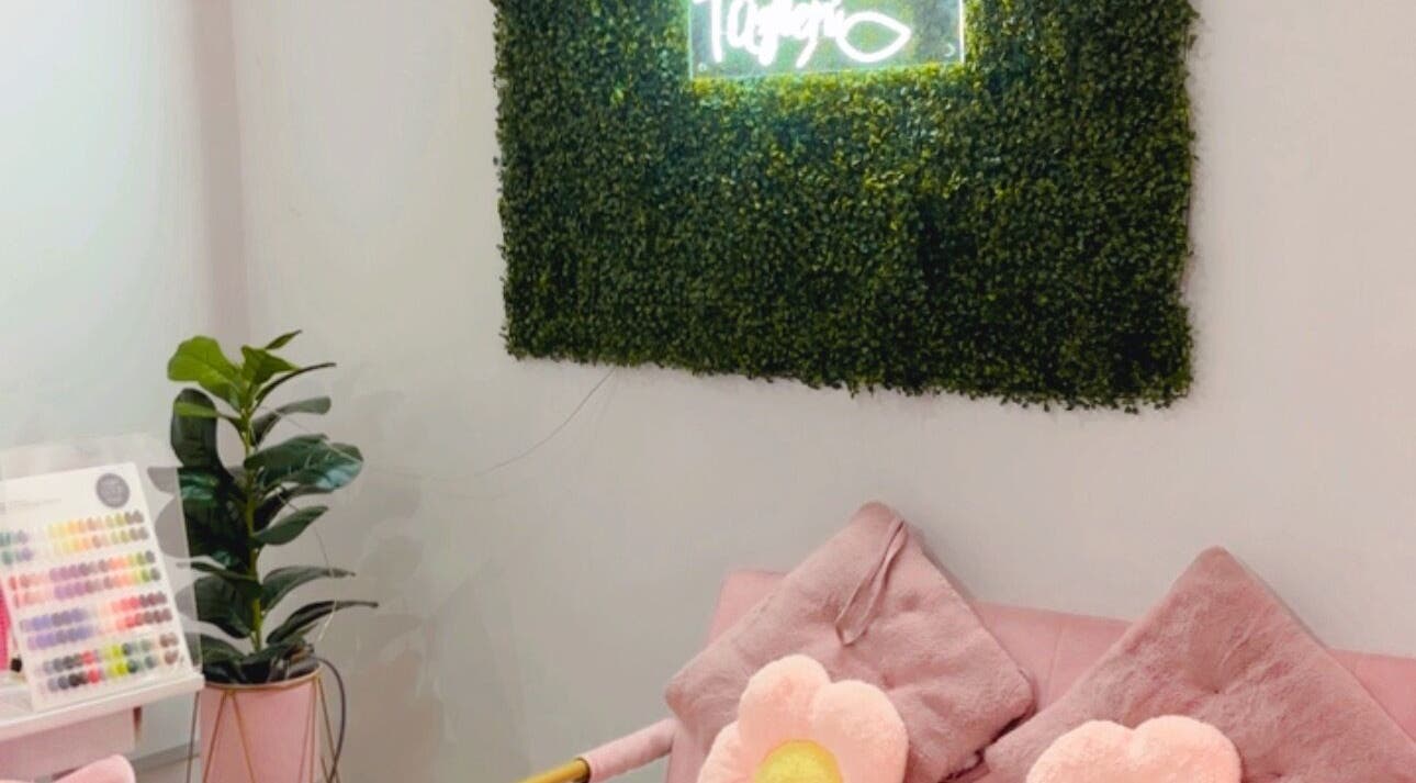 Cozy seating at Ruang Spa Azren in Kuala Lumpur, MY with floral cushions and lush greenery.