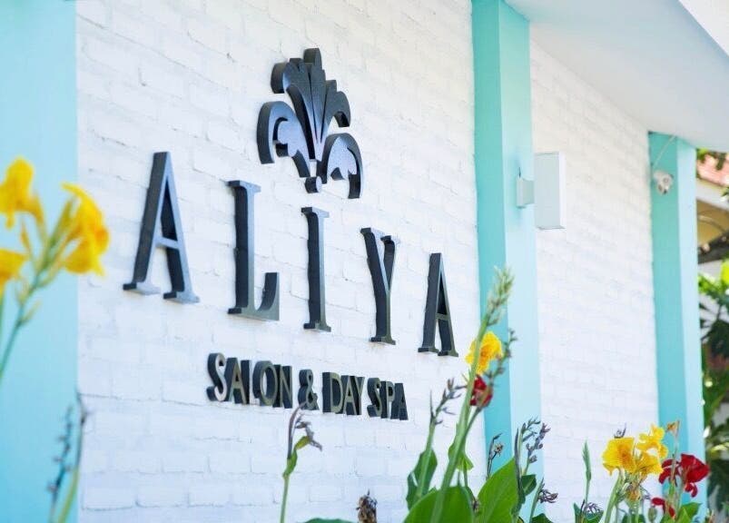 Exterior facade of Aliya Wellness Spa, adorned with flowers, in Bali, Bali, ID.