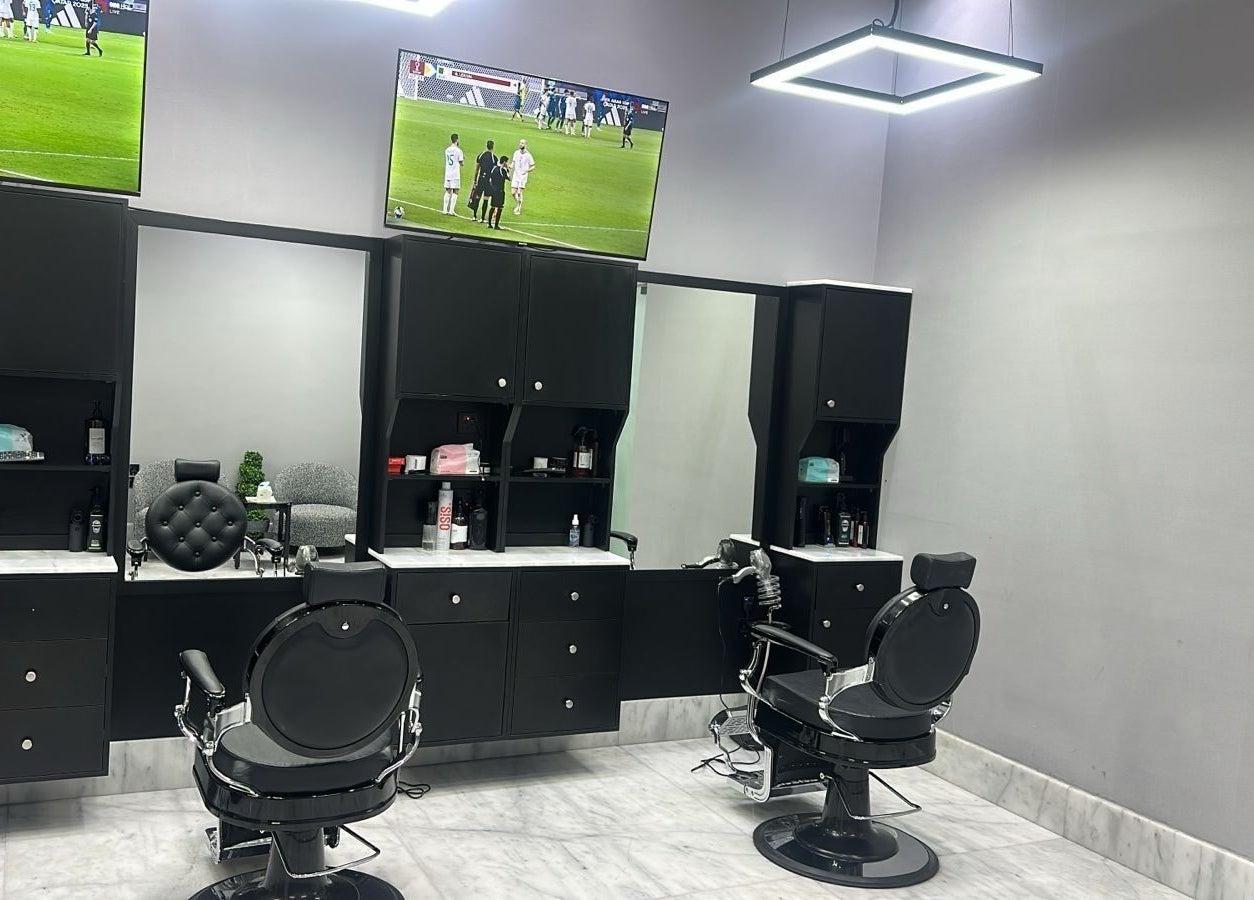 Interior of AJ barbershop in Jeddah, Makkah Province, SA, showcasing a modern barber chair and sleek design.