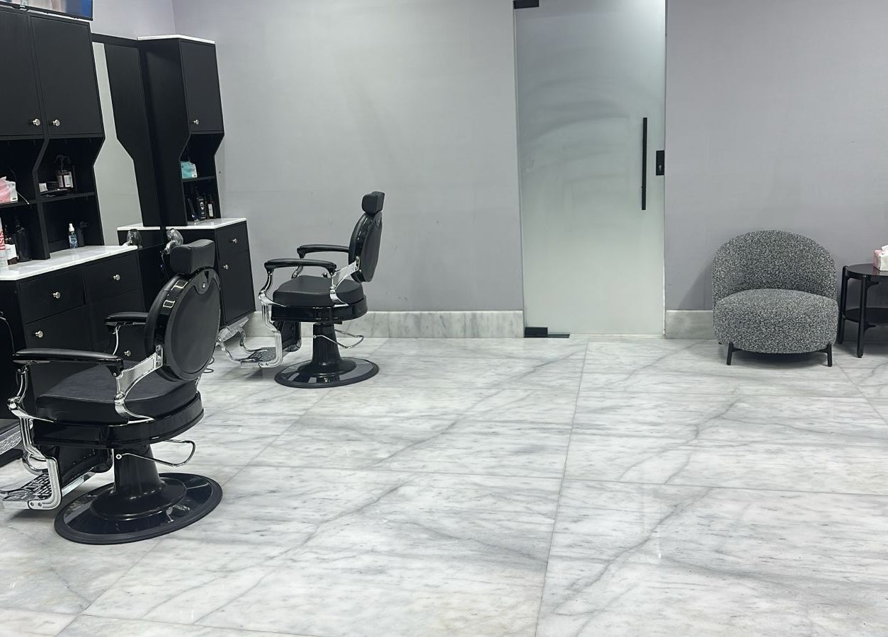 Chic interior of AJ barbershop, Jeddah, Makkah Province, SA with sleek barber chairs and minimalist design.