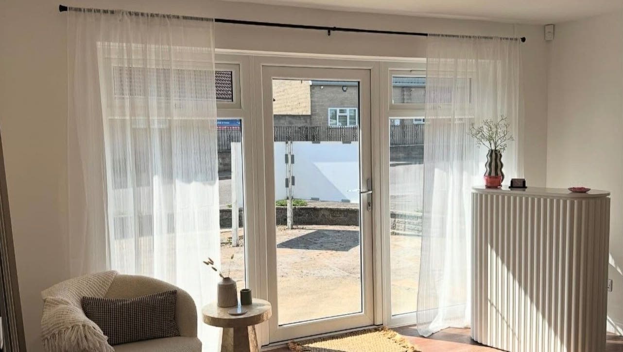 Bright and cozy seating area at Styled By Soph, Somerton, England, GB with natural light and minimalist decor.